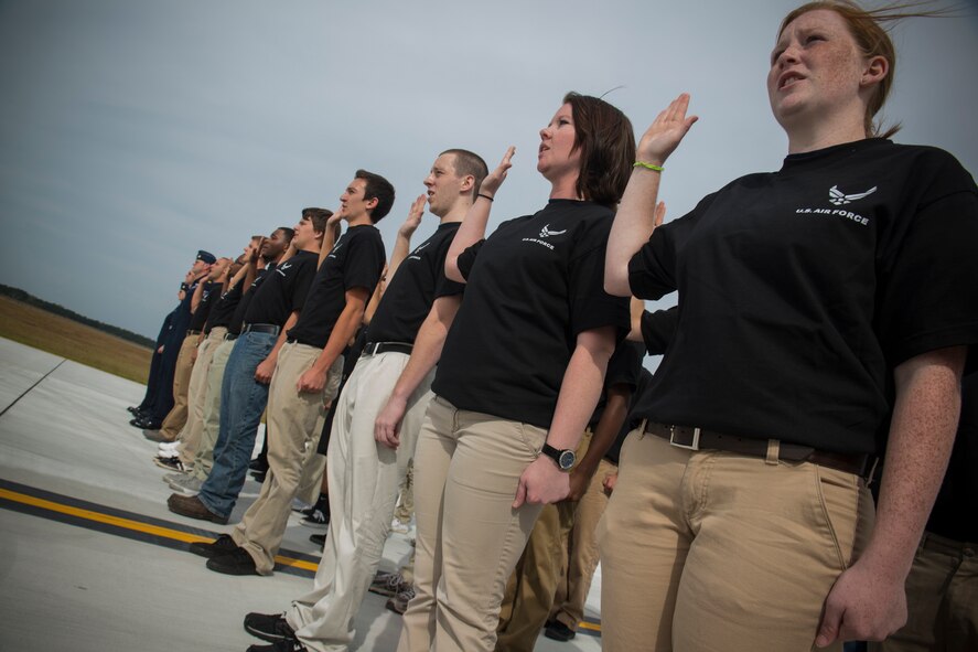 Thirty young men and women of the Air Force delayed entry program recite the Oath of Enlistment during the Moody Air Force Base, Ga., Legacy of Liberty Open House air show Oct. 27, 2012. The U.S. Air Force Thunderbirds Flight Demonstration Team administered the enlistment ceremony for the future Airmen. (U.S. Air Force photo by Staff Sgt. Jamal D. Sutter/Released) 