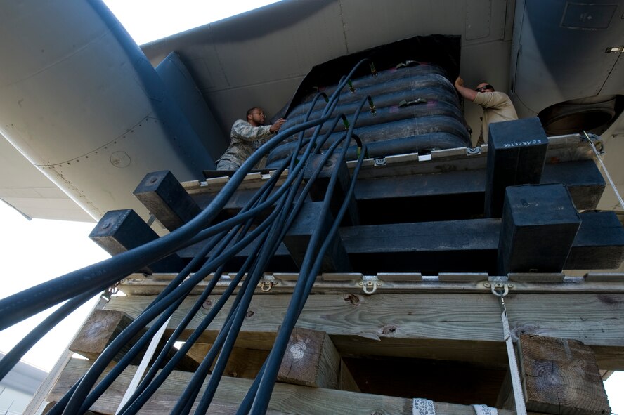 U.S. Air Force Senior Airman Tory Menifee, left, and Senior Airman Nicholas Webbe, repair and reclamation technicians with 1st Special Operations Equipment Maintenance Squadron position F-4 lifting bags at the Open House on Hurlburt Field Fla., Oct. 27, 2012. Team Hurlburt’s Open House gave the public an inside look at the 1st Special Operations Wing and some of the other units located at Hurlburt Field. Ground displays of several types of Special Operations aircraft including the AC-130U Spooky Gunship and the CV-22 Osprey, as well as various other types of specialized military equipment from across base were featured.
 (U.S. Air Force Photo/ Staff Sgt. John Bainter)
