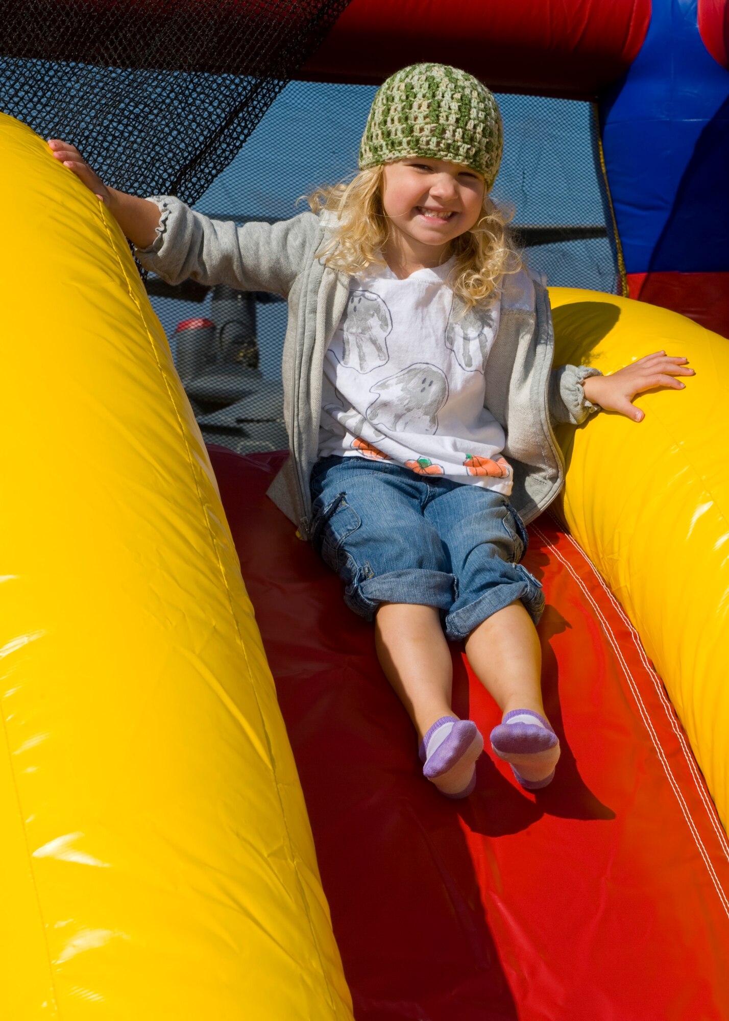 Daisy Grace Crawford, daughter of Landon Crawford, a hydraulics technician with 1st Special Operations Maintenance squadron slides down a bouncy house slide at the Open House on Hurlburt Field, Fla., Oct. 27, 2012. Team Hurlburt’s Open House gave the public an inside look at the 1st Special Operations Wing and some of the other units located at Hurlburt Field. Ground displays of several types of Special Operations aircraft including the AC-130U Spooky Gunship and the CV-22 Osprey, as well as various other types of specialized military equipment from across base were featured.
 (U.S. Air Force Photo/ Staff Sgt. John Bainter)
