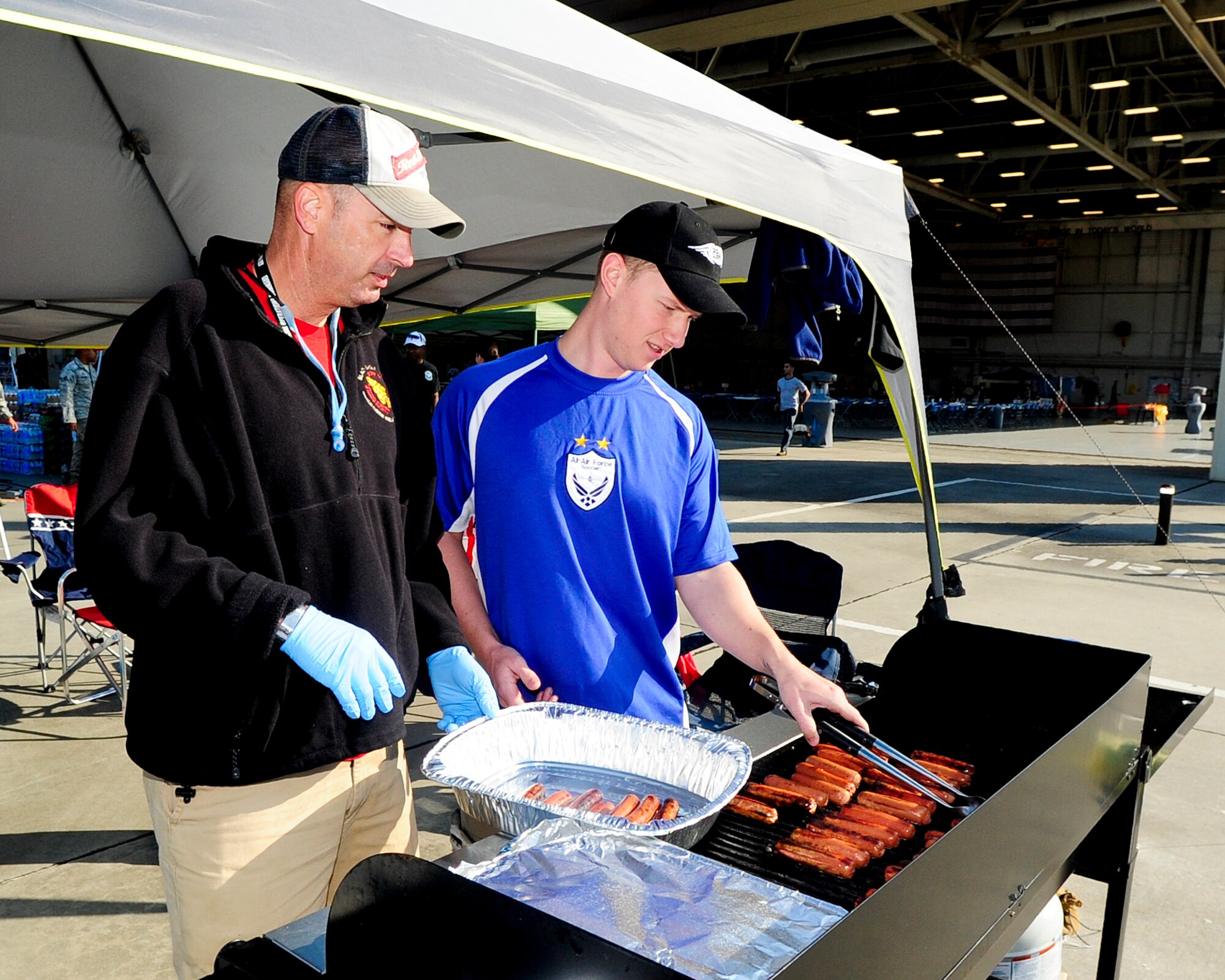 The Hurlburt Field First Sergeants group cooks hotdogs for the Team Hurlburt community during the Hurlburt Field Open House at Hurlburt Field, Fla., Oct. 27, 2012. Team Hurlburt?s Open House gave the public an inside look at the 1st Special Operations Wing and some of the other units located at Hurlburt Field. Ground displays of several types of Special Operations aircraft including the AC-130U Spooky Gunship and the CV-22 Osprey, as well as various other types of specialized military equipment from across base were featured. (U.S. Air Force photo/Airman 1st Class Christopher Williams)
