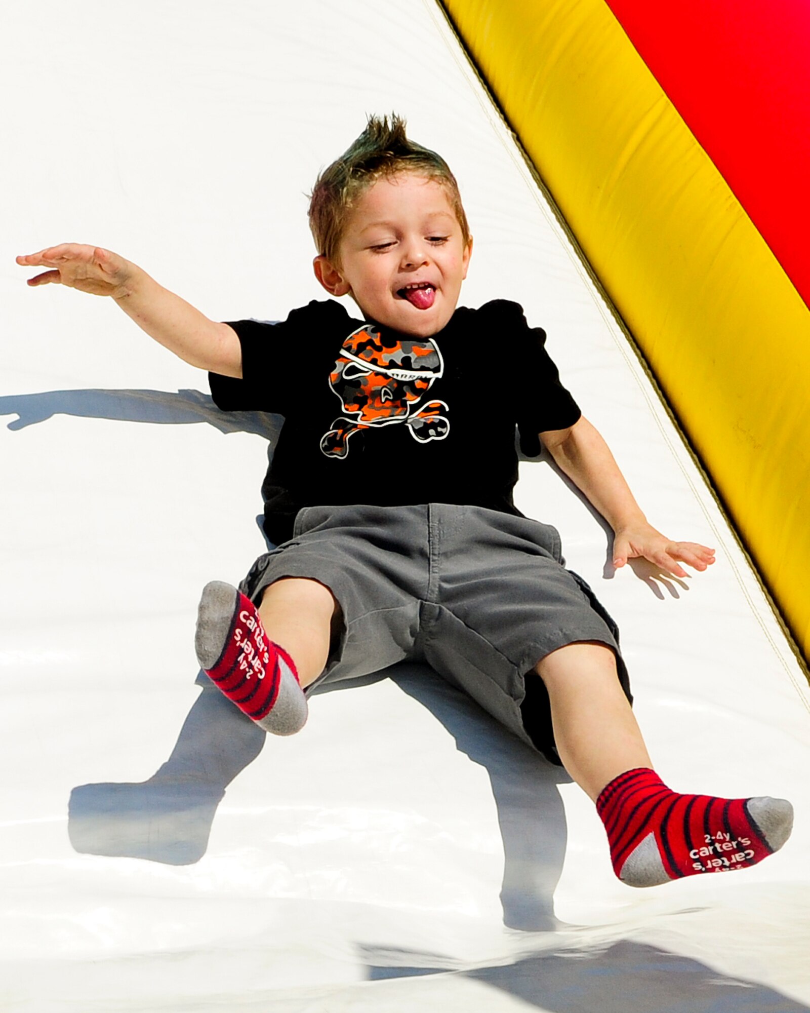 Brennan Boyle, son of Master Sgt. Gisele Boyle, from 1st Special Operations Maintenance Operations Support, slides down the bouncy slide during the Team Hurlburt Open House at Hurlburt Field, Fla., Oct. 27, 2012. The Open House gave the public an inside look at Hurlburt Field?s many missions and allowed Team Hurlburt to show appreciation to the local community for their continued support to the base. (U.S. Air Force photo/Airman 1st Class Christopher Williams)
