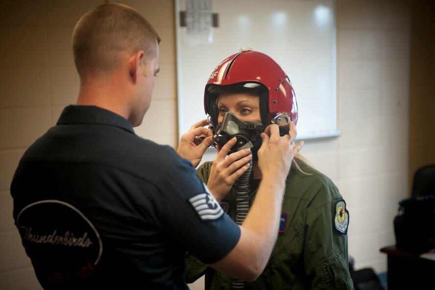 Jade Bulecza, WTXL reporter from Tallahassee, Fla., gets fitted for her media flight with the U.S. Air Force Thunderbird Flight Demonstration Team  at Moody Air Force Base, Ga., Oct. 25, 2012. Bulecza went through fitting and training so she knew how to handle certain situations while airborne. (U.S. Air Force photo by Airman 1st Class Paul Francis/Released)
