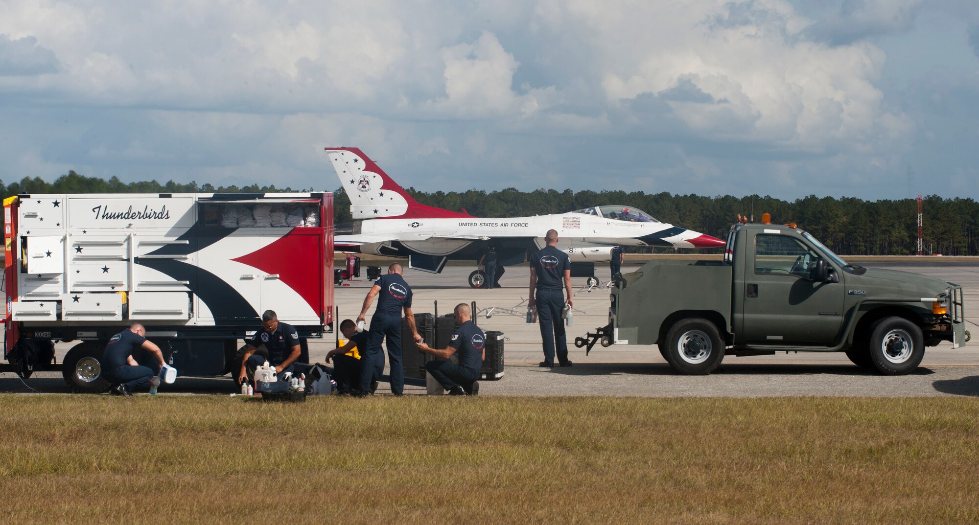 U.S. Air Force Thunderbird Flight Demonstration Team  members begin to secure an F-16C/D Fighting Falcon at Moody Air Force Base, Ga., Oct. 25, 2012. As each plane taxied in, the remaining Thunderbirds flew over the skies of Moody for all to see. (U.S. Air Force photo by Airman 1st Class Paul Francis/Released) 
