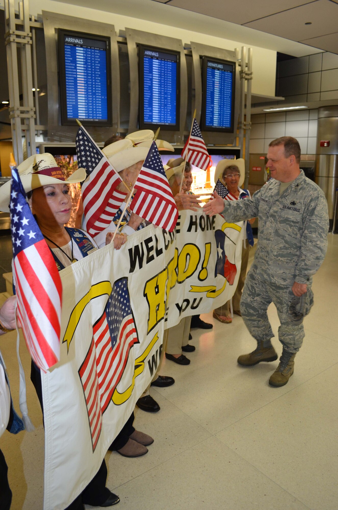 Col. Craig S. Petersen, 433rd Mission Support Group commander, thanks the members of the San Antonio Amabassadors for their support in welcoming home 25 members of the 433rd Security Forces Squadron on Oct. 25, 2012 at the San Antonio International Airport. 