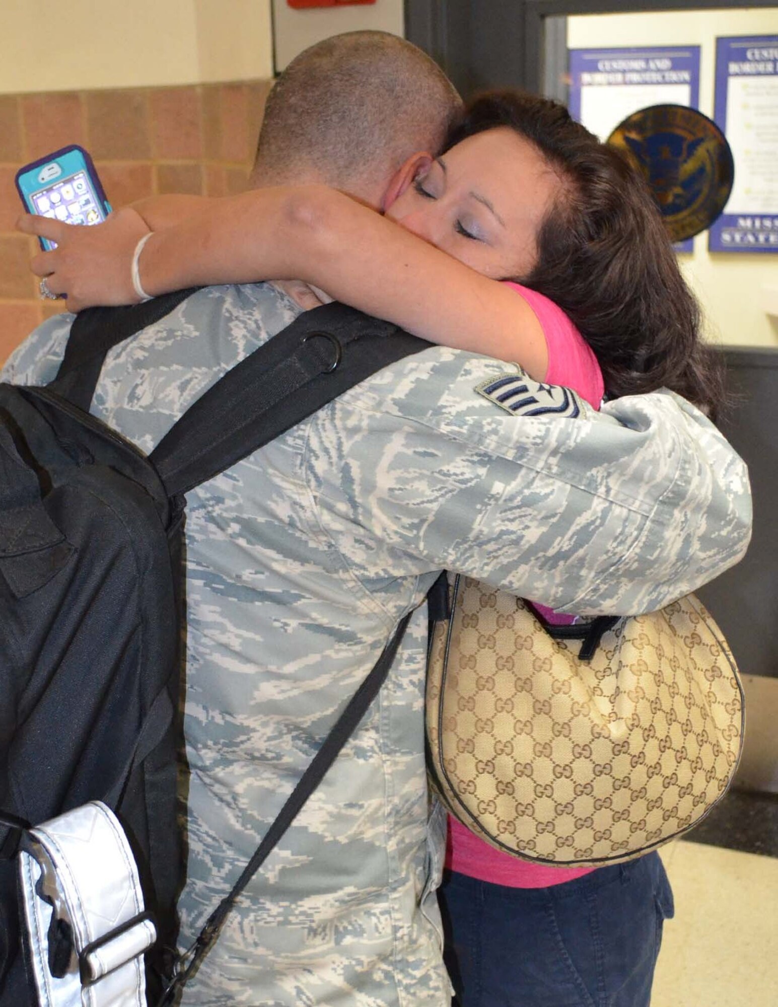 Tech. Sgt. Neal Allen, 433rd Security Forces Squadron, embraces his wife Maria, at the San Antonio International Airport on Oct. 25, 2012. 