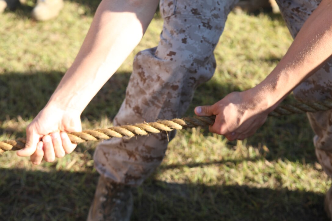 A Marine with 2nd Maintenance Battalion, 2nd Marine Logistics Group grasps a rope moments before the start of the unit’s tug-of-war challenge aboard Camp Lejeune, N.C., Oct. 24, 2012. The battalion hosted a field meet to test its Marines’ strength and endurance while building unit cohesion and pride.