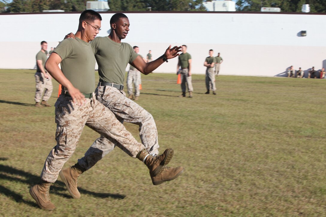 Lance Cpls. Dwayne Woods and Michael Dinh, both with 2nd Maintenance Battalion, 2nd Marine Logistics Group, hop their way to second place during the unit’s three-legged race aboard Camp Lejeune, N.C., Oct. 24, 2012. The battalion held various competitions as part of a field meet meant to challenge the Marines and build their sense of unity. 
