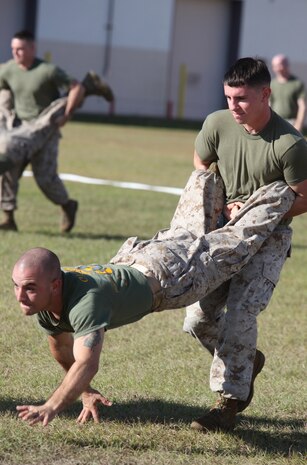 Two Marines race during a wheel-barrel competition at the 2nd Maintenance Battalion, 2nd Marine Logistics Group field meet aboard Camp Lejeune, N.C., Oct. 24, 2012. The unit held the competitions to develop a sense of unity within its companies and reward the Marines for their hard work. 