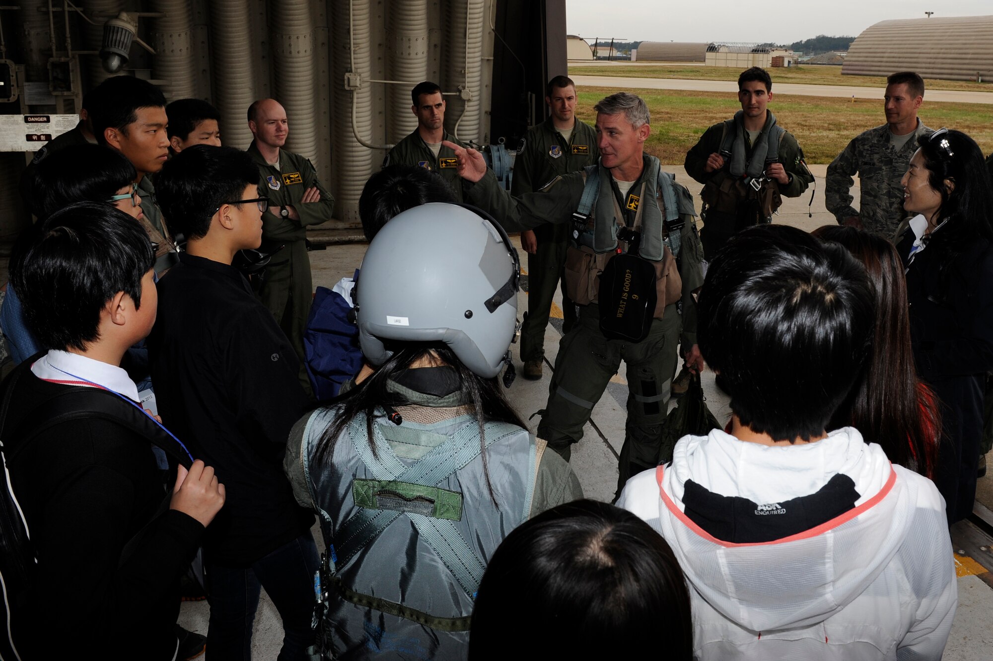 Col. John Pearse, 8th Fighter Wing commander talks to Korean students about how the honorary pilot program strengthens the bonds between the U.S. Air Force and Republic of Korea Air Force at Kunsan Air Base, Republic of Korea, Oct. 23, 2012. The 16 junior and high schoolers toured the aircraft control tower , learned how to land with a parachute in a virtual simulator and had to the opportunity to don pilot gear. (U.S. Air Force photo/Senior Airman Marcus Morris) 