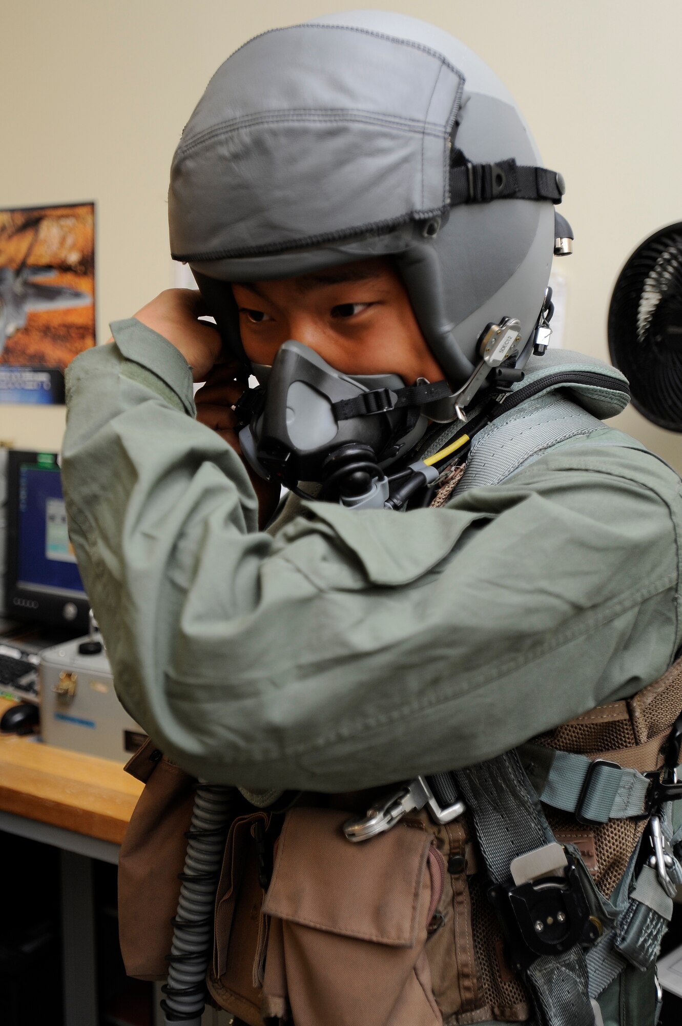 Jo Ha-Eun, a local Korean high school student dons pilot gear during the honorary pilot program at Kunsan Air Base, Republic of Korea, Oct. 24, 2012. The 16 students from eight local junior and high schools took turns suiting up like pilots. (U.S. Air force photo/Senior Airman Marcus Morris)