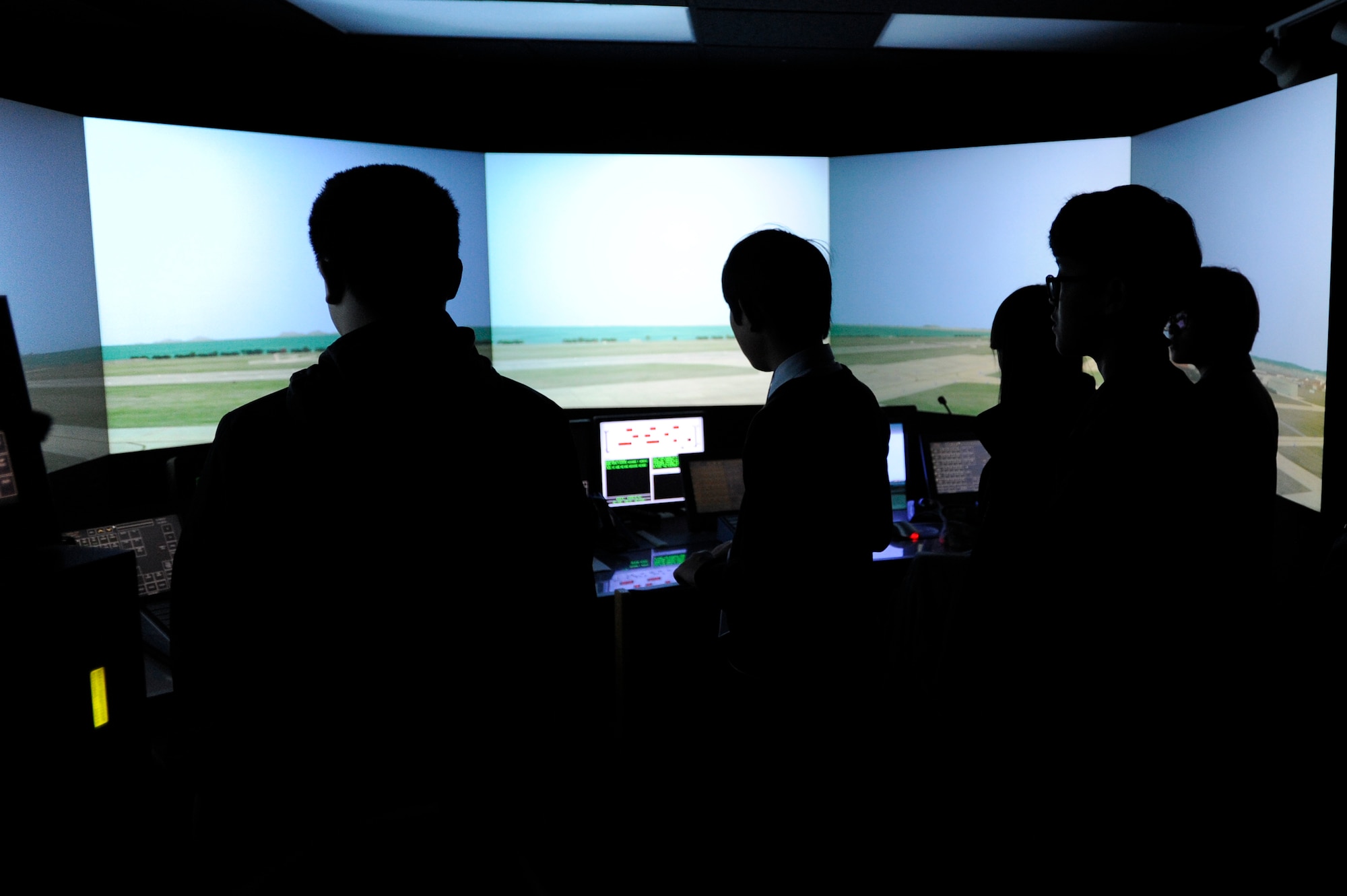 Junior and high school students from eight different institutions are shown the control tower simulator during the honorary pilot program at Kunsan Air Base, Republic of Korea, Oct. 24, 2012. The simulator gives control tower members a 180-degree view and during training can project weather, vehicles on the flightline and day or night senarios. (U.S. Air Force photo/Senior Airman Marcus Morris) 