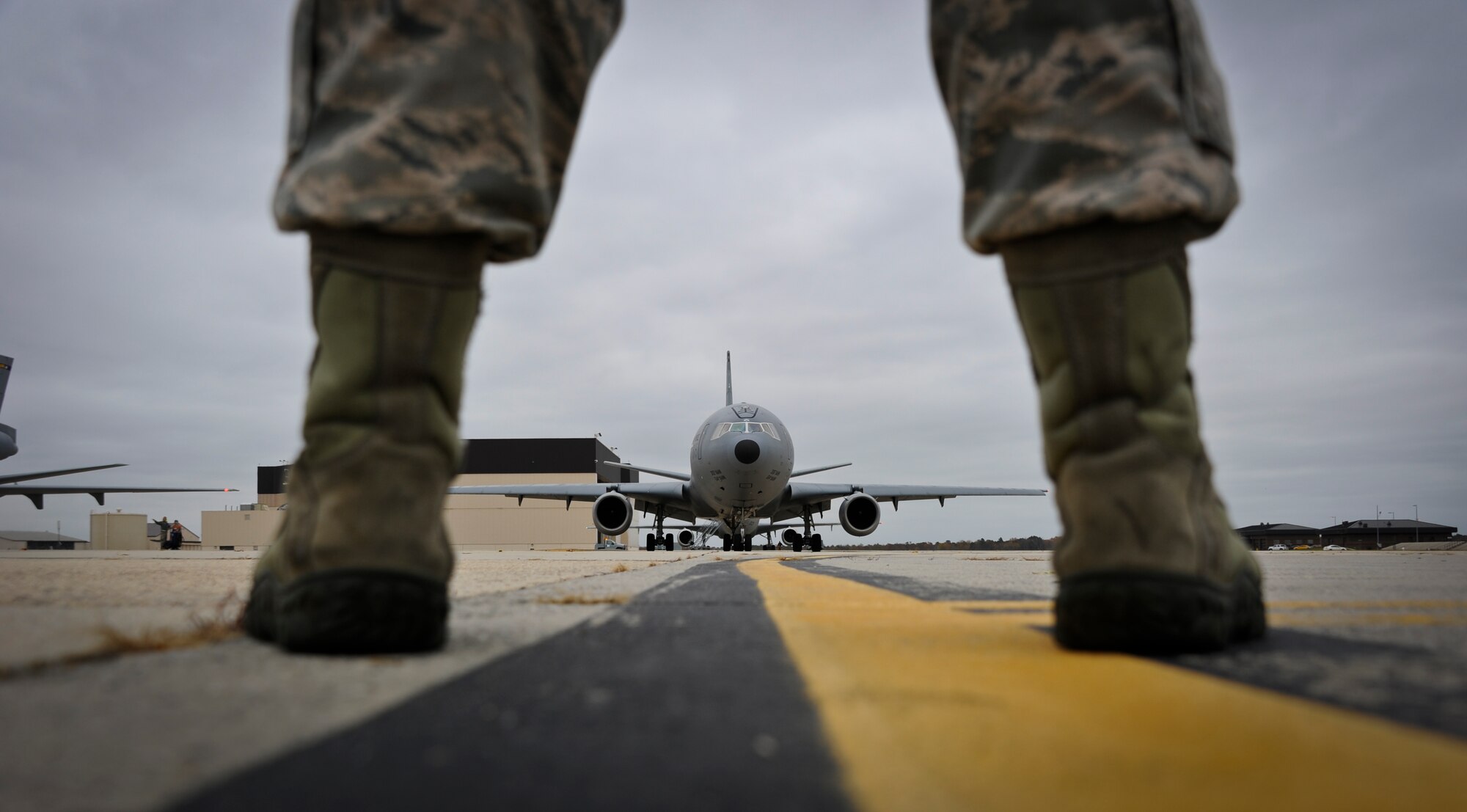 JOINT BASE MCGUIRE-DIX-LAKEHURST, N.J. -- A maintainer from the 605th Aircraft Maintenance Squadron waits to marshal a KC-10 Extender en route to the runway here Oct. 28, 2012. The 305th Air Mobility Wing's aircraft are being evacuated to alternate locations throughout the United States to avoid possible damage from Hurricane Sandy. (U.S. Air Force photo by Staff Sgt. David Carbajal/Released)