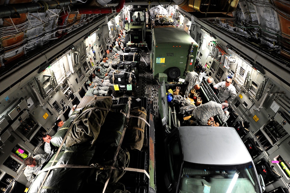 JOINT BASE MCGUIRE-DIX-LAKEHURST, N.J. -- U.S. Air Force Airmen assigned to the 621st Contingency Response Wing at Joint Base McGuire-Dix-Lakehurst, N.J. fly aboard a JB MDL-based C-17 Globemaster III, Oct. 28, 2012.  The CRW was deploying  an air mobility contingency response team of approximately 65 Airmen from JB MDL to MacDill Air Force Base, Fla. out of the path of Hurricane Sandy. This movement will ensure Air Mobility Command maintains the capability to respond to natural disasters or worldwide contingencies.   (U.S. Air Force photo by Tech. Sgt.  Parker Gyokeres) (Released)