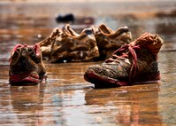 Muddy sneakers and socks sit soaking in the muddy water as participants of the Emerald Coast MudRun for Orphans clean up and wash off May 19 in Niceville, Fla.  Active-duty and reserve service members from Duke, Hurlburt Field, Eglin and more came out to get dirty in either the morning or afternoon 5K challenges. (U.S. Air Force photo/Tech. Sgt. Samuel King Jr.)