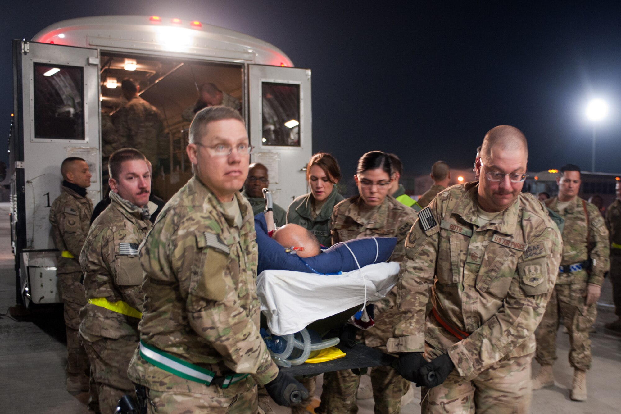 U.S. Air Force Senior Master Sgt. Isaac Reese (foreground left), 455th Expeditionary Civil Engineer Squadron operations superintendent, and MSgt Daniel Roth, 455th Expeditionary Mission Support Group 1st sergeant (far right), help transfer a wounded servicemember from the Contingency Aeromedical Staging Facility to an awaiting C-17 Globemaster III at Bagram Airfield, Afghanistan, Oct. 27, 2012. BAF’s 1st Sergeants volunteered together at the Contingency Aeromedical Staging Facility to help transport servicemembers from CJTH to receive continued medical care. (U.S. Air Force Photo/Staff Sgt. Jeff Nevison)