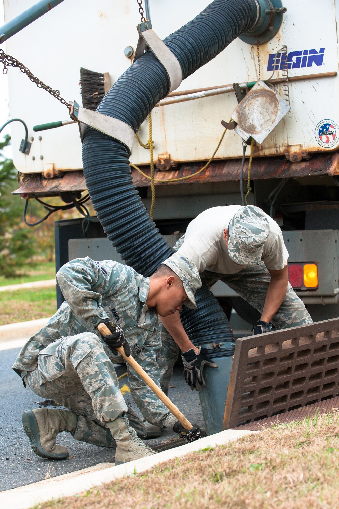 Senior Airman Edwin Velez and Airman 1st. Class Philip Ramos 87th Civil Engineer Squadron heavy equipment operators, clear the storm drain Oct. 26, 2012, on Joint Base McGuire-Dix-Lakehurst, N.J., in preparation of Hurricane Sandy. Velez hails from Edison, N.J., and Ramos hails from Las Vegas, Nev. (U.S. Air Force photo by Russ Meseroll/Released)