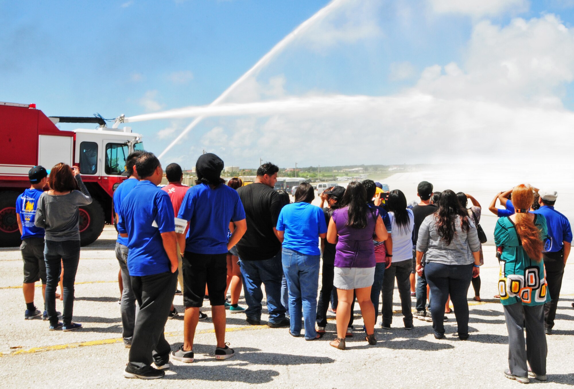 ANDERSEN AIR FORCE BASE, Guam – Guam Community College students and chaperons watch as the Andersen’s fire department demonstrates the strength of the fire hoses on their fire trucks to students and chaperons from the Guam Community College here, Oct. 19. The students and chaperons visited the base for a career advancement tour. (U.S. Air Force photo/Airman 1st Class Marianique Santos/Released)
