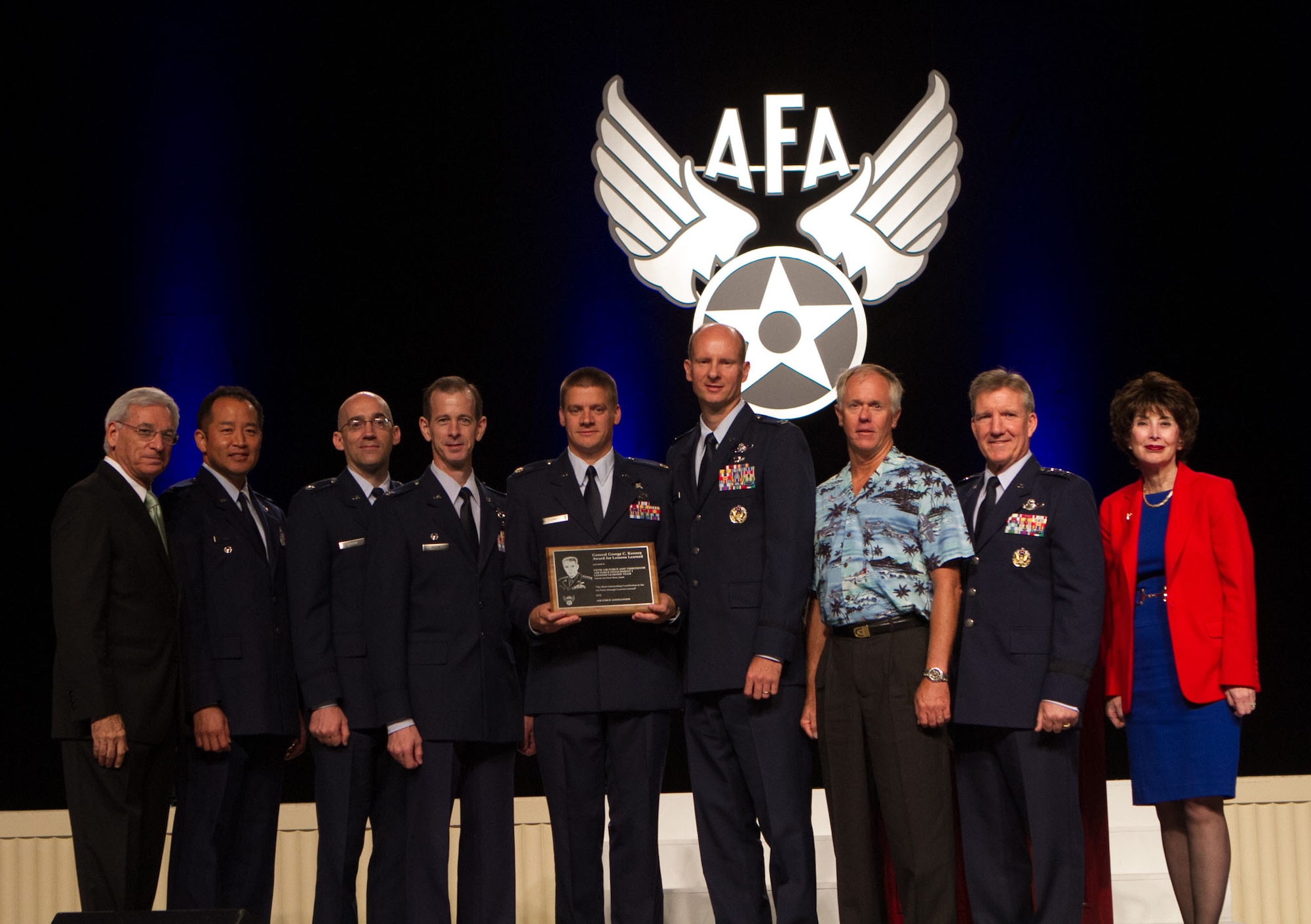 Left to right, Mr. Sandy Schlitt, Air Force Association Chairman of the Board, Col. Stuart Lum, then-5th Air Force Director of Staff, Lt. Col. Kyle Novak, then-13th Air Force Chief of Analyses and Assessments, Col. Marc Reese, then-13th AF Detachment 1 commander, Maj. David Caswell, then-7th Air Force A8/A9, Col. Martin Winkler, 5th AF A3/A5, Mr. Mark Reid, FFRDC-MITRE, 13th AF/A9, Gen. Herbert "Hawk" Carlisle, Pacific Air Forces commander, and Dr. Jacqueline Henningsen, director for Studies & Analyses, Assessments and Lessons Learned, Headquarters U.S. Air Force, pose with the Gen. George C. Kenney Award for Lessons Learned during the AFA Air and Space and Technology Exposition Sept. 17, 2012 in Washington, D.C. (Courtesy photo)