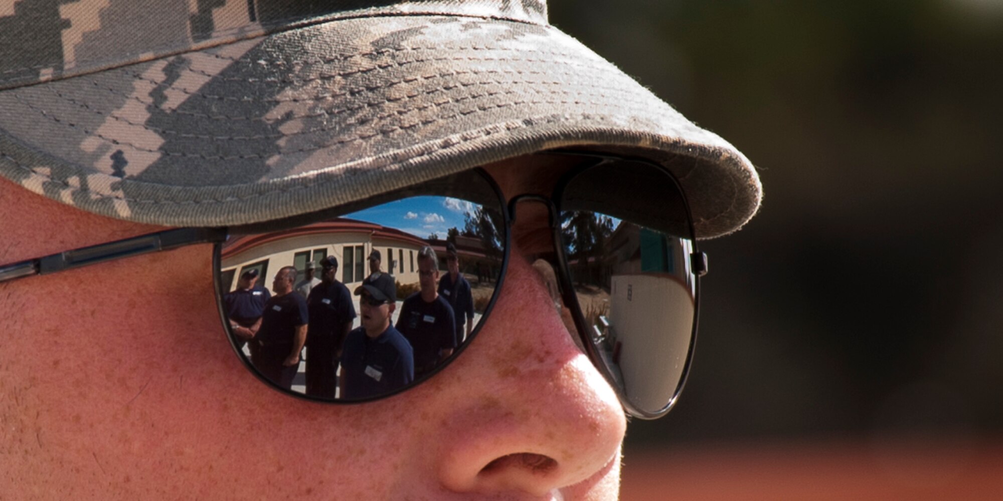 Trainees from local police and fire departments are reflected in the glasses of Travis Air Force Base honorguard instructor SSgt Kyle King, from 571 Global MobilitySquadron.  The Travis Base Honorguard regularly trains personnel  from fire, police , and other outside agencies in full Funeral Honor Ceremony proceedures including Pall Baring, Six man Flag Fold and artillery Fire Party.    (Released - U.S. Air Force Photograph/Heide Couch)