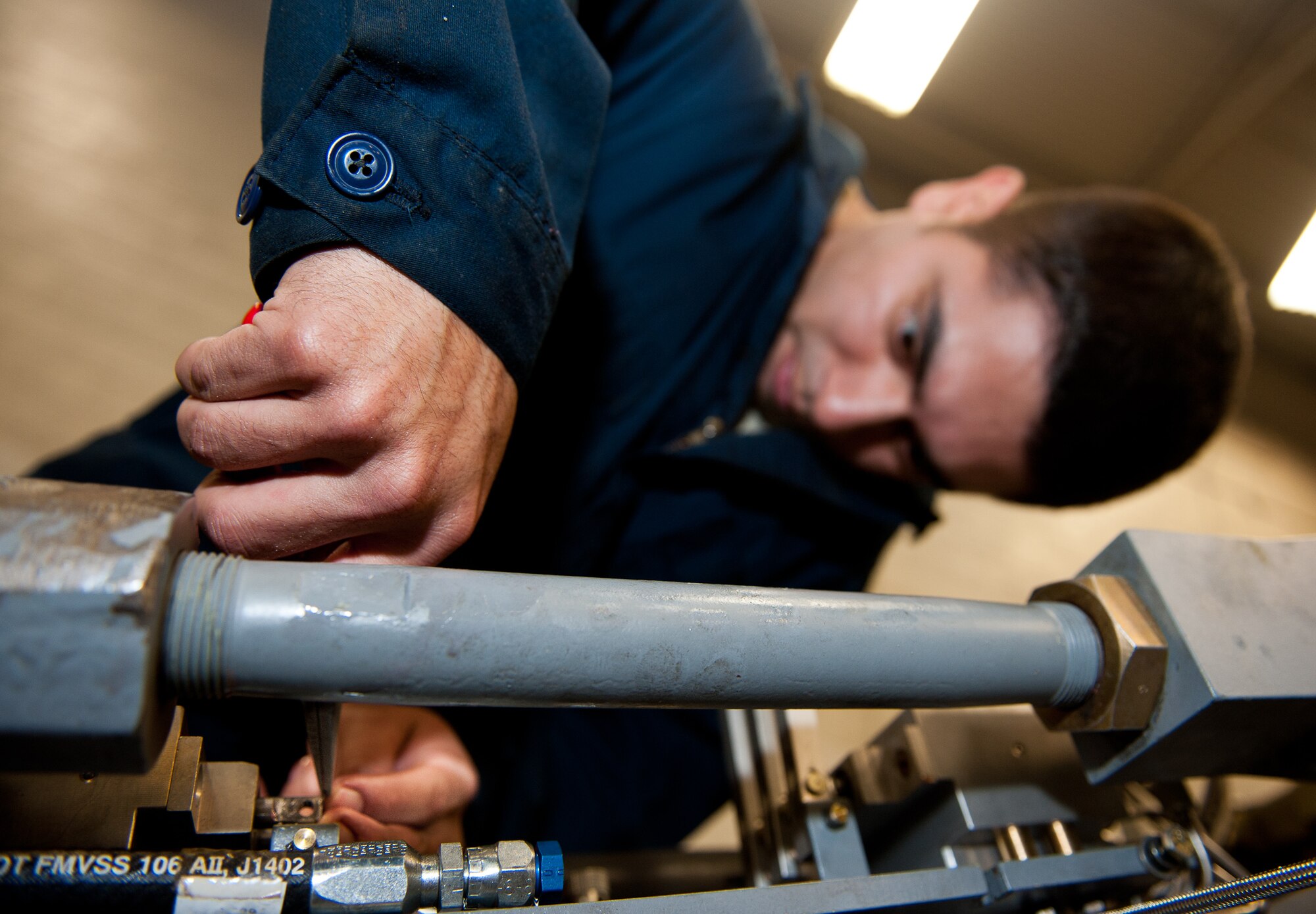 Staff Sgt. George Solis, 28th Maintenance Squadron aerospace ground equipment technician, installs snap rings on a munitions truck during scheduled maintenance in the AGE shop on Ellsworth Air Force Base, S.D., Oct. 25, 2012. AGE technicians are responsible for the serviceability of all support equipment on Ellsworth. (U.S. Air Force photo by Airman 1st Class Kate Thornton-Maurer/Released) 