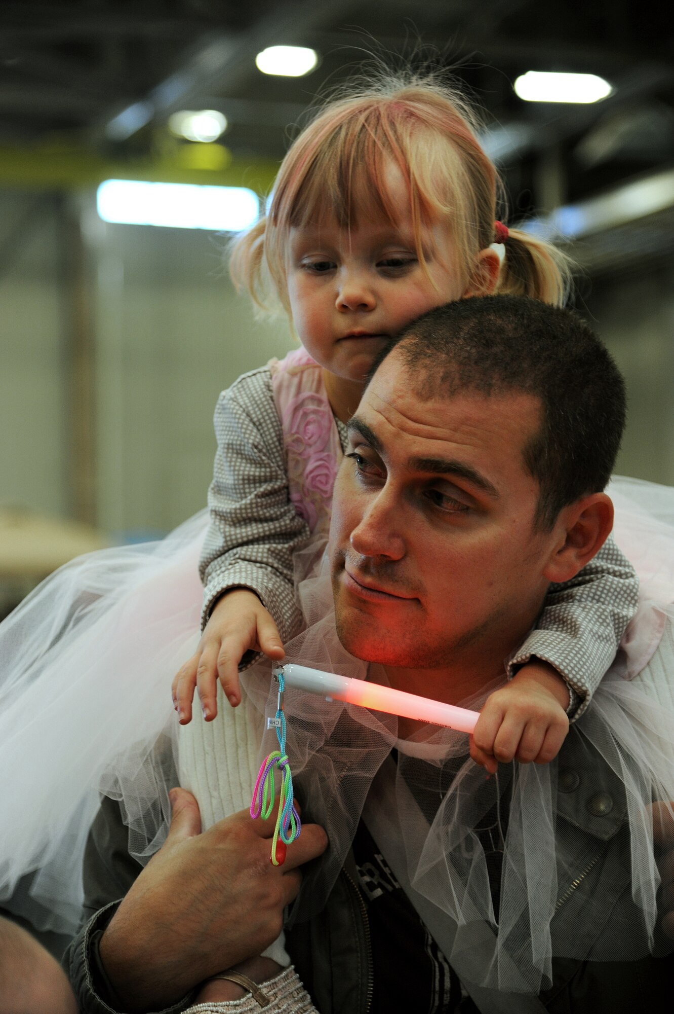 U.S. Air Force Staff Sgt. Bryan Daugherty, 27th Special Operations Aircraft Maintenance Squadron, and his daughter Olivia enjoy each other's company during the Fall Festival at Cannon Air Force Base, N.M., Oct. 27, 2012. With games, food and a live band, this event was popular for base families as more than 500 people joined in the festivities.  (U.S. Air Force photo/Senior Airman Jette Carr)