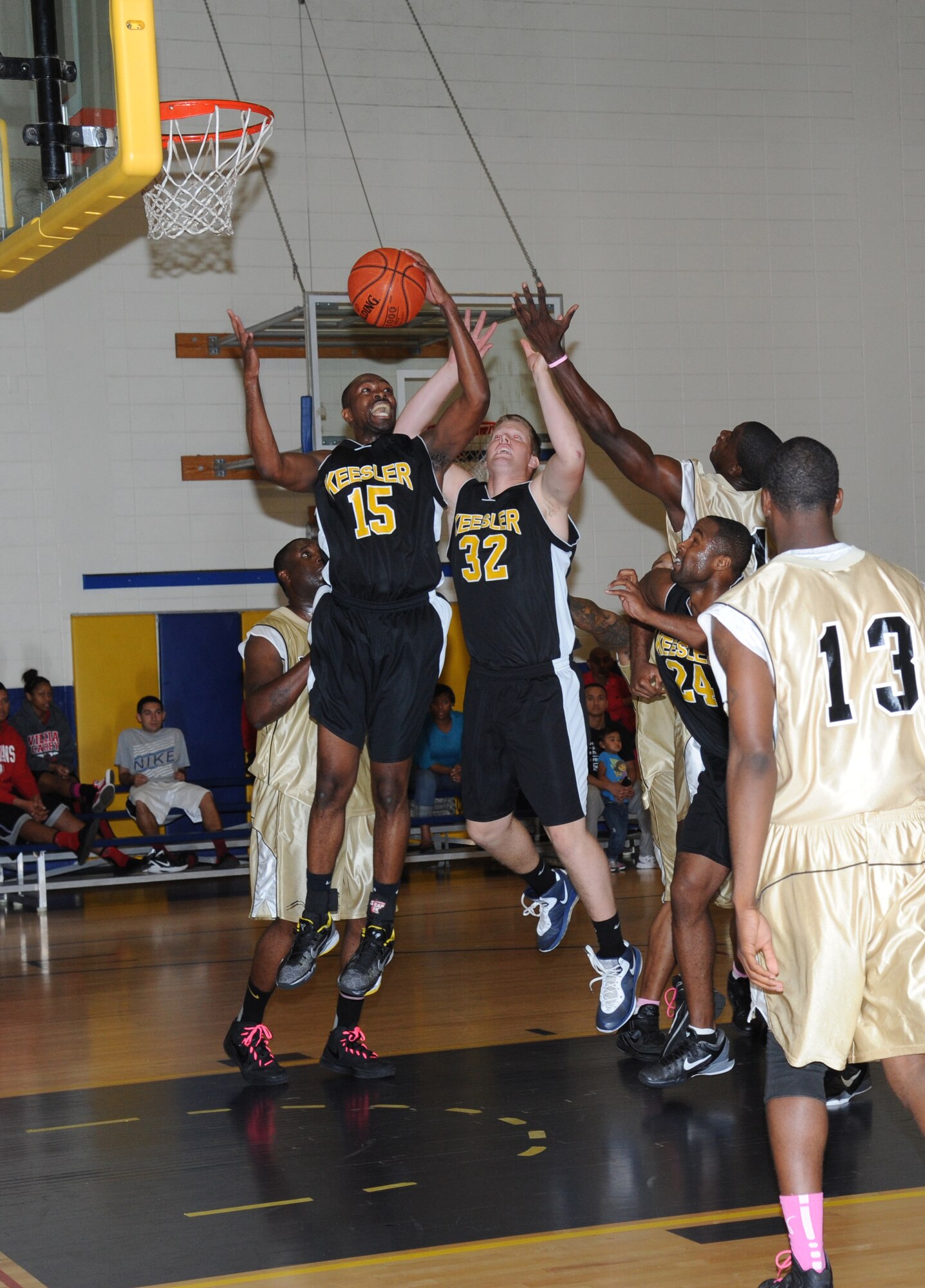Alvin Holmes and Shaun McQuiston, Keesler, jump for the rebound during a varsity basketball game against Fort Benning Oct. 27, 2012, at the Blake Fitness Center, Keesler Air Force Base, Miss. Fort Benning defeated Keesler 78-76.  (U.S. Air Force photo by Kemberly Groue)