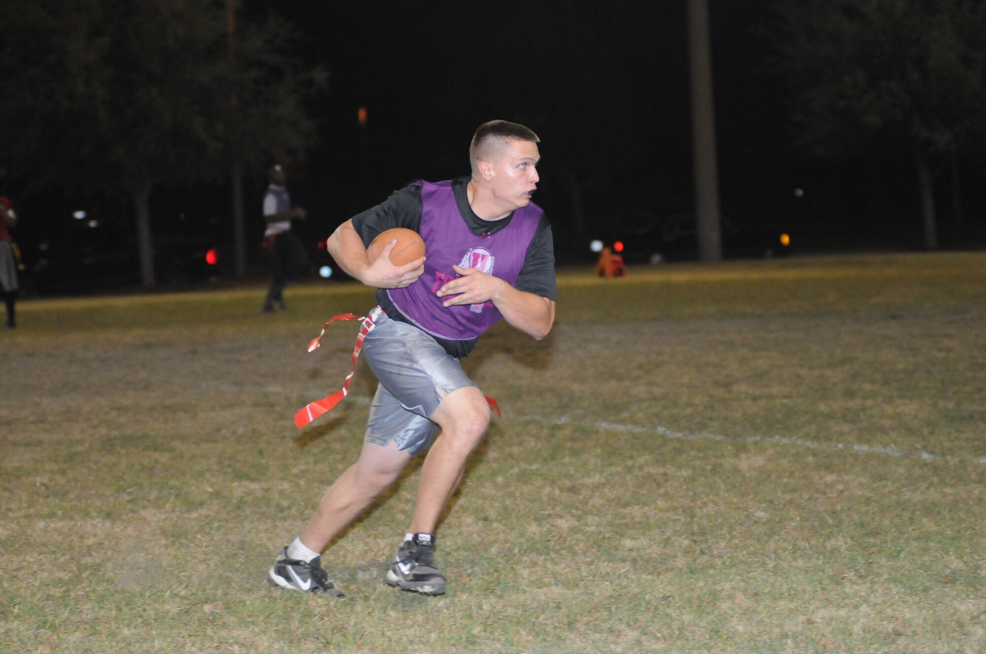 Austin Shick, 403rd Wing, secures the ball as he gains yards during an intramural flag football game Oct. 25, 2012, at Keesler Air Force Base, Miss. The 403rd Wing defeated the 333rd TRS, 33-20.  (U.S. Air Force photo by Kemberly Groue)
