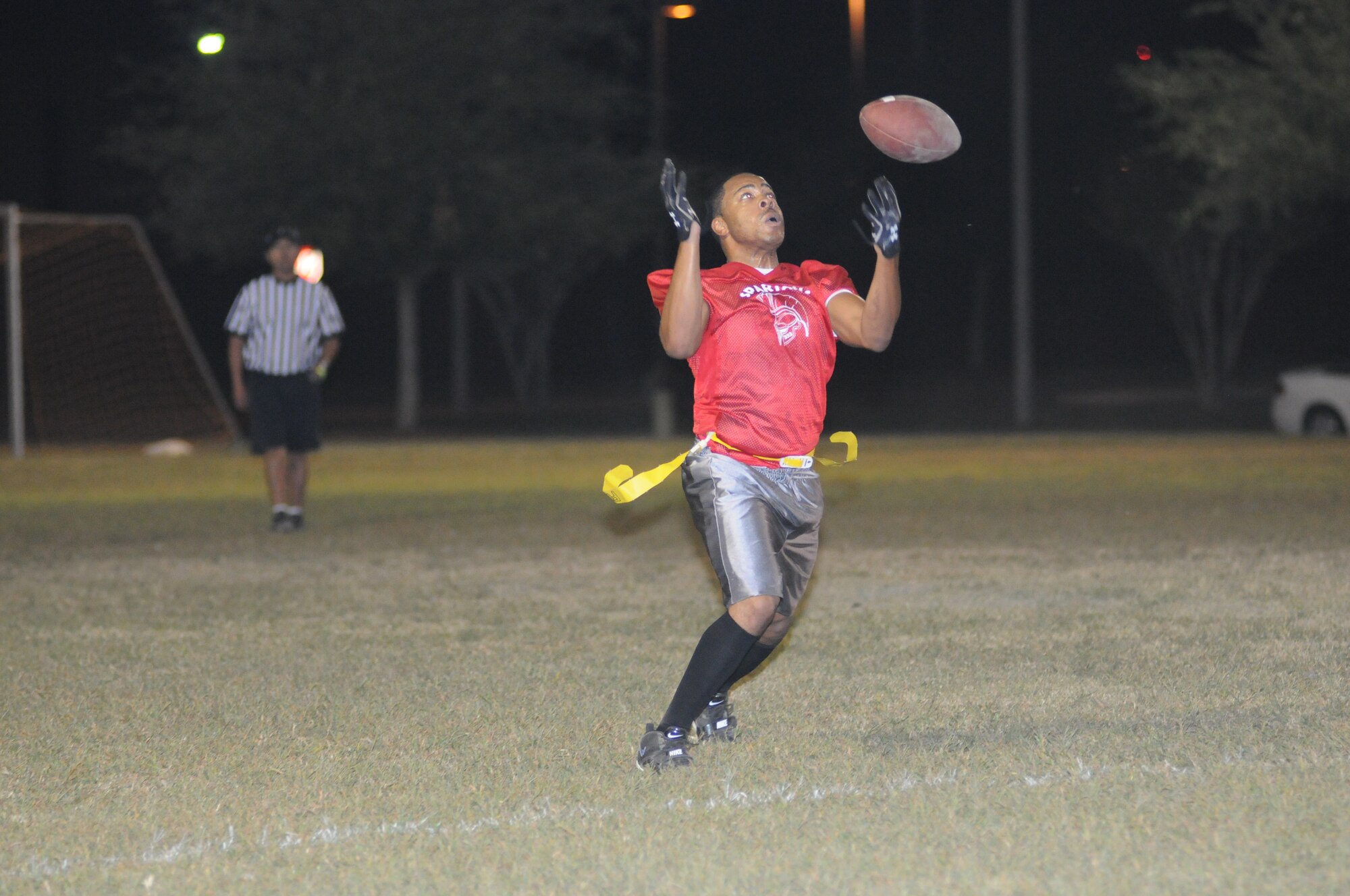 Tarif Williams, 333rd Training Squadron, fumbles the ball in the air before gaining control  during an intramural flag football game Oct. 25, 2012, at Keesler Air Force Base, Miss. The 403rd Wing defeated the 333rd TRS, 33-20.  (U.S. Air Force photo by Kemberly Groue)