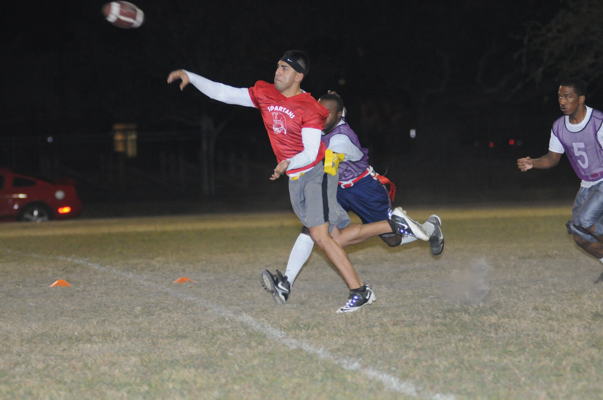 Jon Escamilla, 333rd Training Squadron quarterback, throws a pass as Terrell James, 403rd Wing, closes in for his flag during an intramural flag football game Oct. 25, 2012, at Keesler Air Force Base, Miss. The 403rd Wing defeated the 333rd TRS, 33-20.  (U.S. Air Force photo by Kemberly Groue)