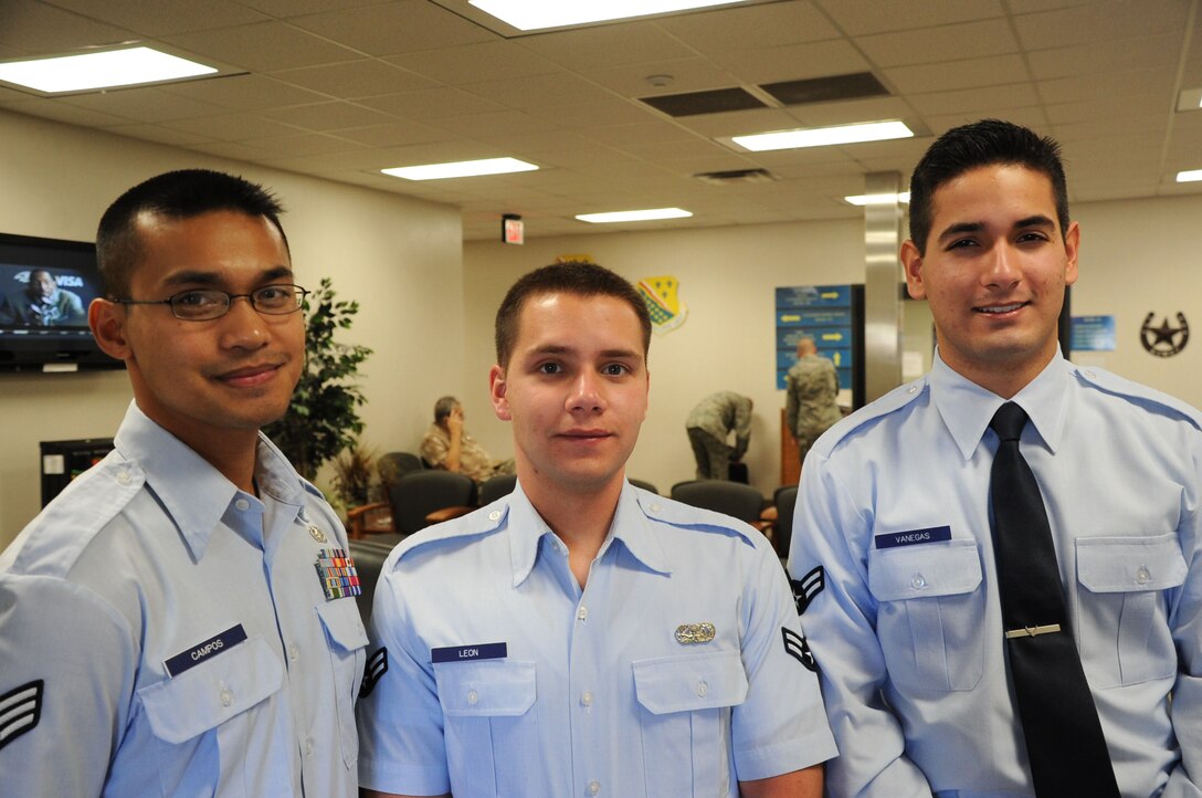 Senior Airman Gil Campos (left), and Airmen 1st Class Chris Leon (center) and Juan Vanegas stand together in the lobby of the 82nd Force Support Squadron at Sheppard Air Force Base, Texas, Oct. 29, 2012.  All three Airmen helped save a local woman's life early in the morning of July 5, 2012, after the woman's vehicle caught on fire after hitting part of a freeway on-ramp. (U.S. Air Force photo/Dan Hawkins)