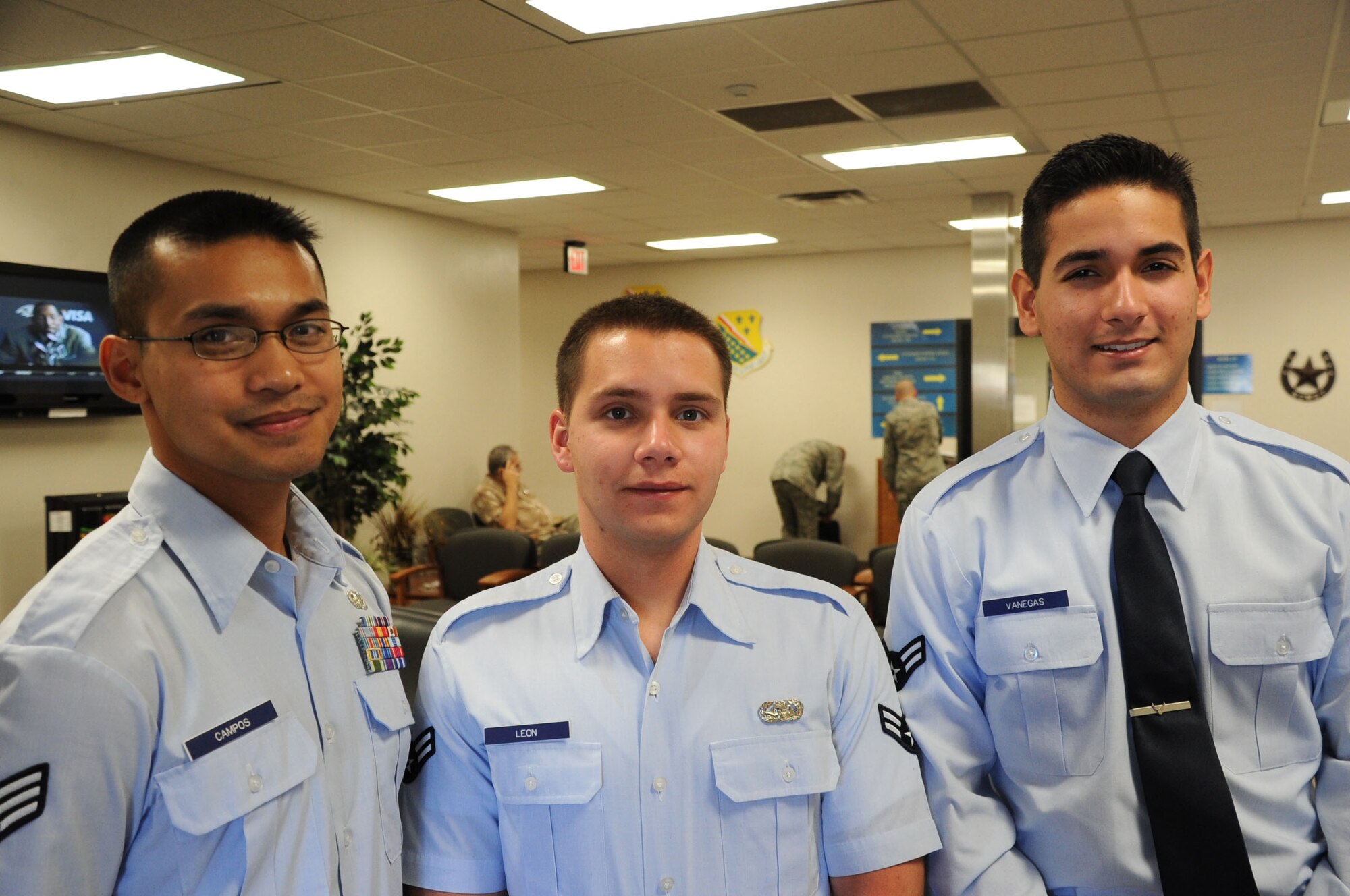 Senior Airman Gil Campos (left), and Airmen 1st Class Chris Leon (center) and Juan Vanegas stand together in the lobby of the 82nd Force Support Squadron at Sheppard Air Force Base, Texas, Oct. 29, 2012.  All three Airmen helped save a local woman's life early in the morning of July 5, 2012, after the woman's vehicle caught on fire after hitting part of a freeway on-ramp. (U.S. Air Force photo/Dan Hawkins)