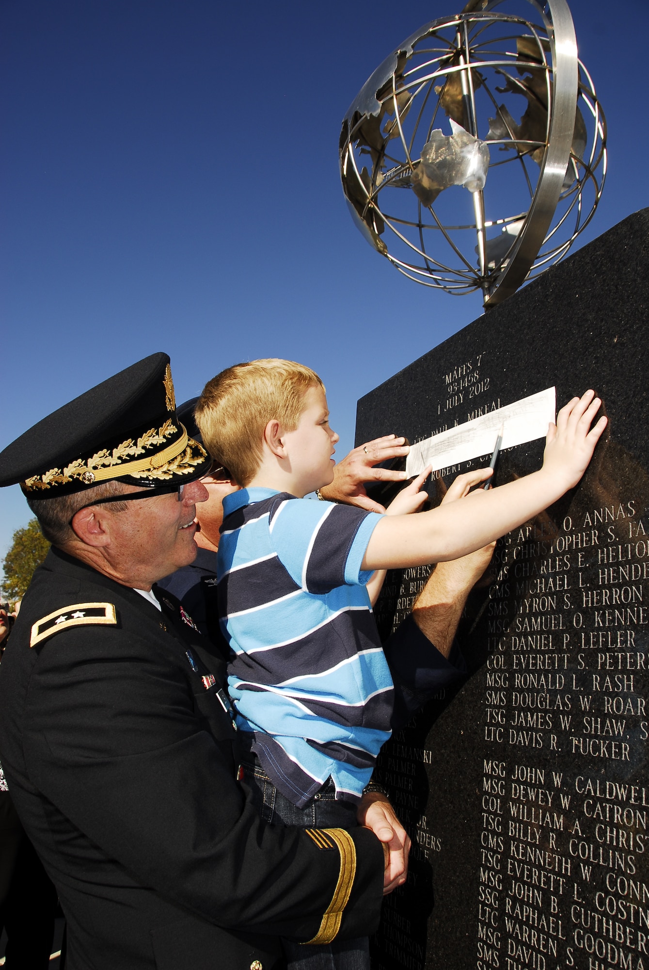 Family members, including those of recently honored  aerial fire fighters and more than a thousand airmen of Charlotte's 145th Airlift Wing, North Carolina Air National Guard attend an annual memorial ceremony as a way to remember all airmen who have died in the year prior, whether a current or past member. Following a flyover of three C-130 Hercules, the aircraft used by the wing to accomplish its missions, the names are pronounced of any Air Guard member who has deceased over the last twelve months to a bagpipe rendition of "Amazing Grace," the formation of airmen at attention for a twenty-one gun salute, then a bugler performing "Taps," and the laying of a wreath in honor and remembrance of those who have passed.  (National Guard photos by Tech Sgt. Rich Kerner, 145th Public Affairs)