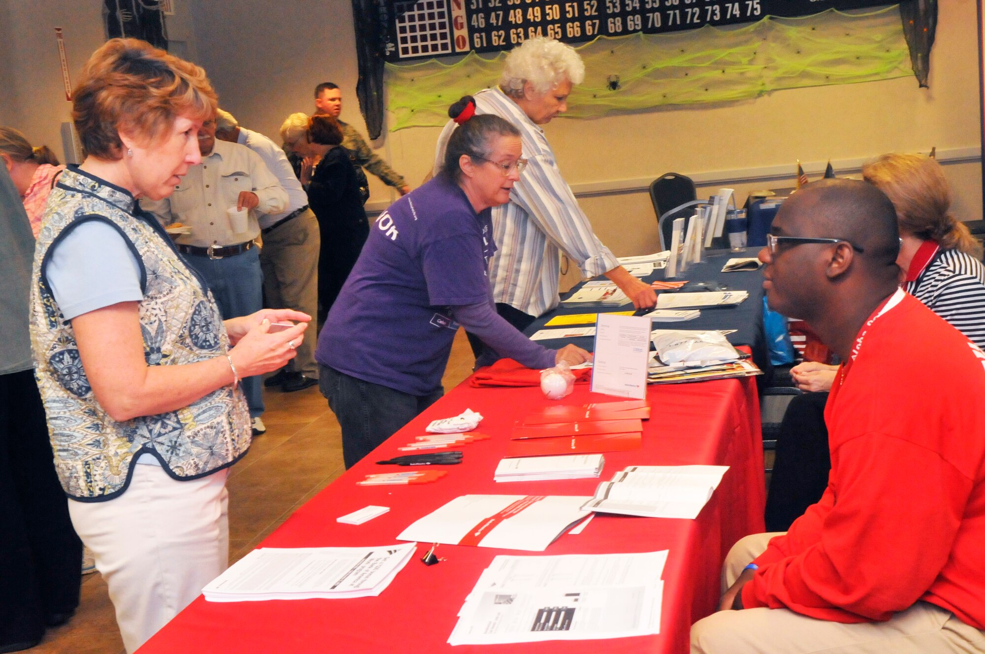 Retirees visit a variety of vendor displays at the Heritage Club during Robins’ Retiree Appreciation Day Saturday. (U. S. Air Force photo/Sue Sapp)