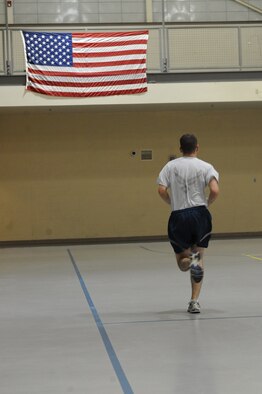 An Airman from the 2nd Maintenance Squadron runs the length of a basketball court for physical training on Barksdale Air Force Base, La., Oct. 25. From intramural sports to aerobics classes, the Fitness Center offers a variety of activities for Airmen to participate in. (U.S. Air Force photo/Senior Airman Micaiah Anthony)(RELEASED)