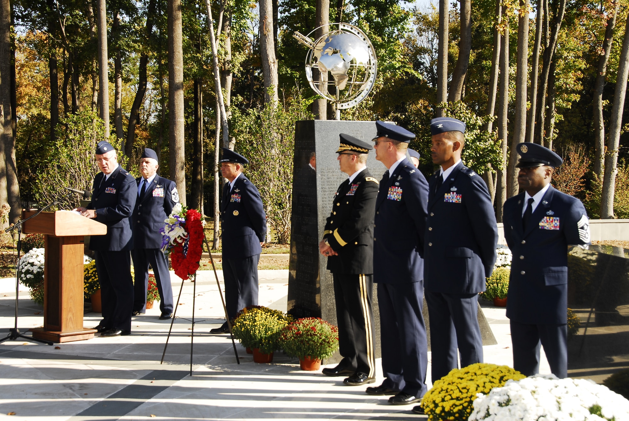 Family members, including those of recently honored aerial fire fighters and more than a thousand airmen of Charlotte's 145th Airlift Wing, North Carolina Air National Guard attend an annual memorial ceremony as a way to remember all airmen who have died in the year prior, whether a current or past member. Following a flyover of three C-130 Hercules, the aircraft used by the wing to accomplish its missions, the names are pronounced of any Air Guard member who has deceased over the last twelve months to a bagpipe rendition of "Amazing Grace," the formation of airmen at attention for a twenty-one gun salute, then a bugler performing "Taps," and the laying of a wreath in honor and remembrance of those who have passed.  (National Guard photos by Tech Sgt. Rich Kerner, 145th Public Affairs)
