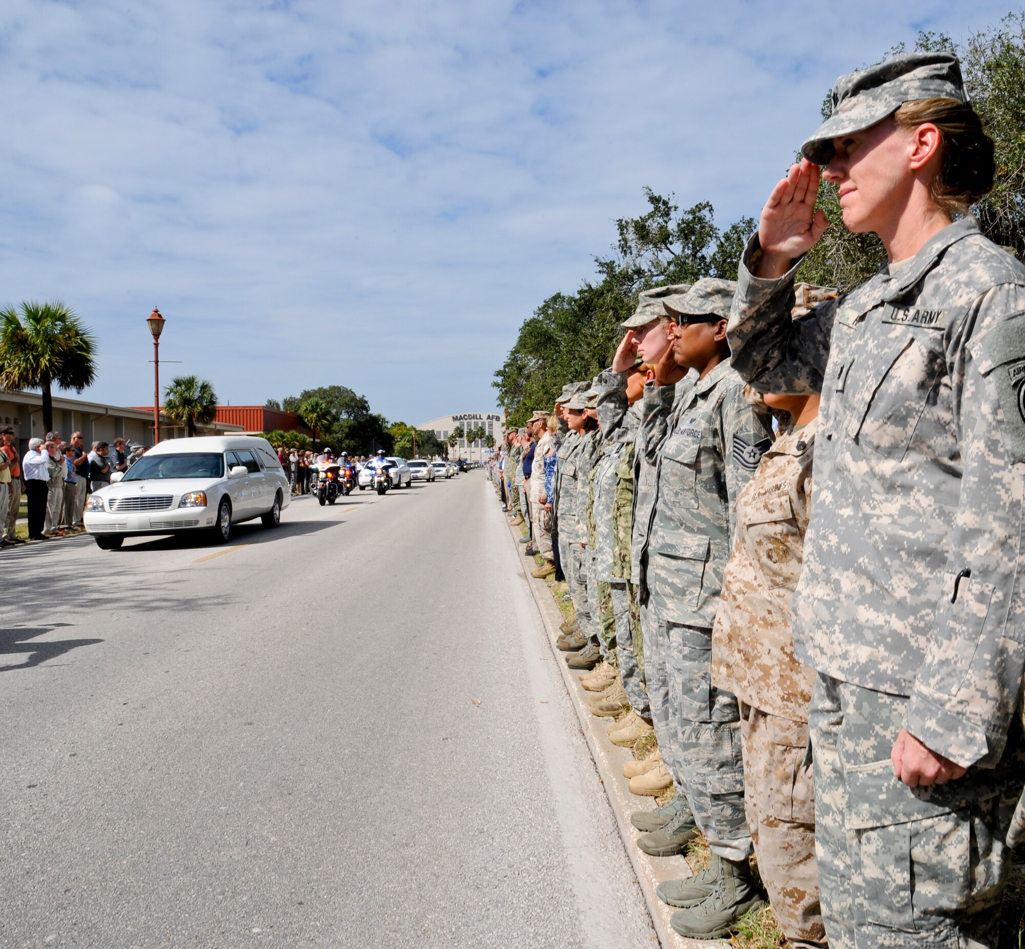 Members of team MacDill render salutes as the remains of Spc. Brittany B. Gordon arrive at MacDill Air Force Base, Fla., Oct. 24, 2012. Gordon died on Oct. 13 due to wounds suffered when enemy forces attacked her unit with an improvised explosive device in Kandahar, Afghanistan. (U.S. Air Force photo by Senior Airman Adam Grant/Released)  