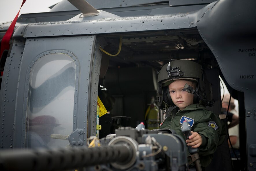 Samuel Scaggs, son of U.S. Air Force Maj. Evan Scaggs, stands behind a 50-caliber machine gun onboard an HH-60G Pave Hawk helicopter during the Moody Air Force Base, Ga., Legacy of Liberty Open House air show Oct. 27, 2012. In addition to aerial acts, the air show featured many static aircraft, which gave guests a chance to get an up-close view of air power. (U.S. Air Force photo by Senior Airman Douglas Ellis/Released)
