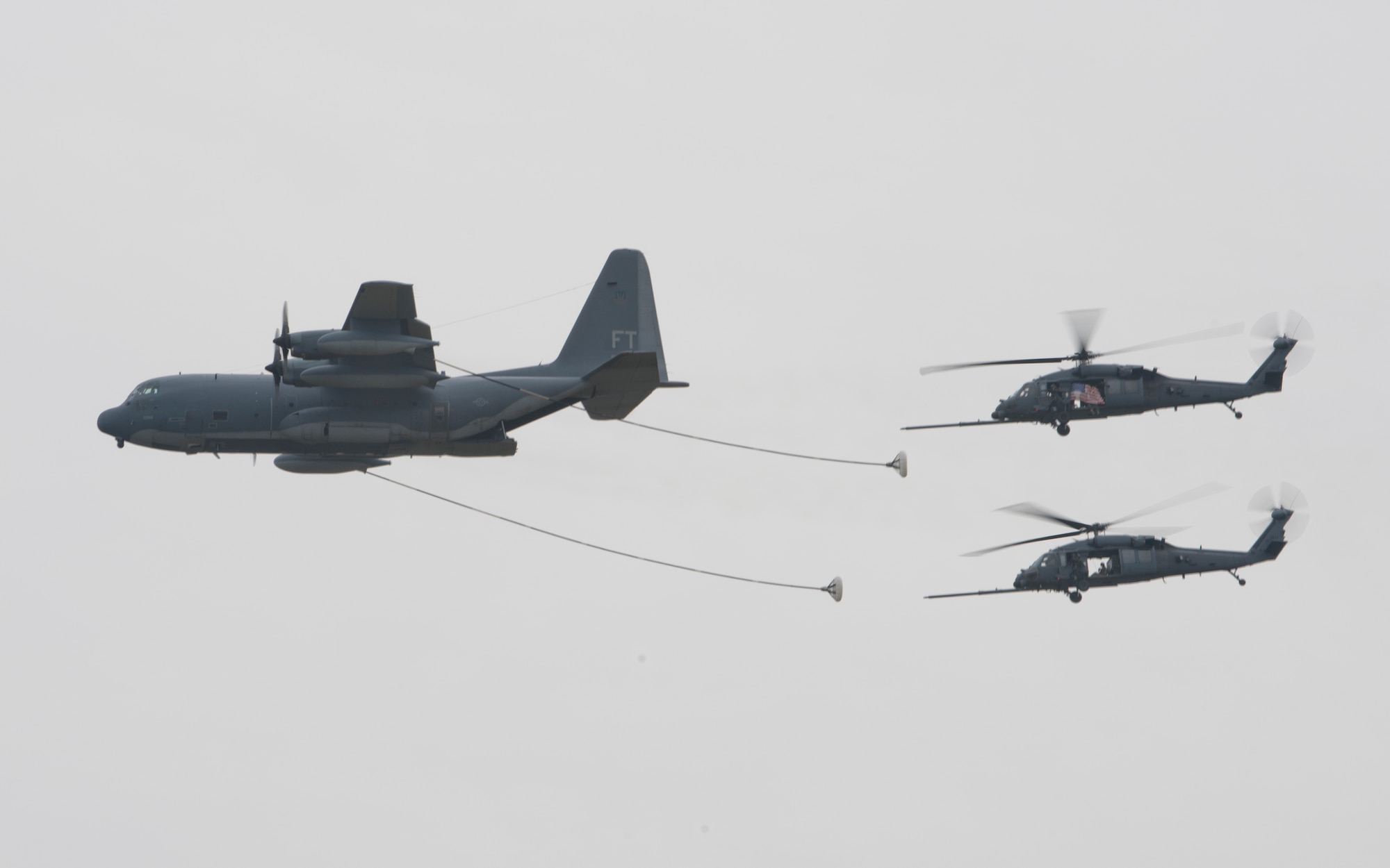 Two HH-60G Pave Hawk helicopters from the 41st Rescue Squadron take on fuel from an HC-130P Combat King during the Moody Air Force Base, Ga., Legacy of Liberty Open House air show Oct. 27, 2012.The in-flight fueling process was put on display after the combat demonstration. (U.S. Air Force photo by Senior Airman Douglas Ellis/Released)
