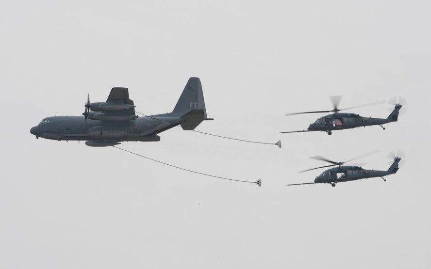 Two HH-60G Pave Hawk helicopters from the 41st Rescue Squadron take on fuel from an HC-130P Combat King during the Moody Air Force Base, Ga., Legacy of Liberty Open House air show Oct. 27, 2012.The in-flight fueling process was put on display after the combat demonstration. (U.S. Air Force photo by Senior Airman Douglas Ellis/Released)
