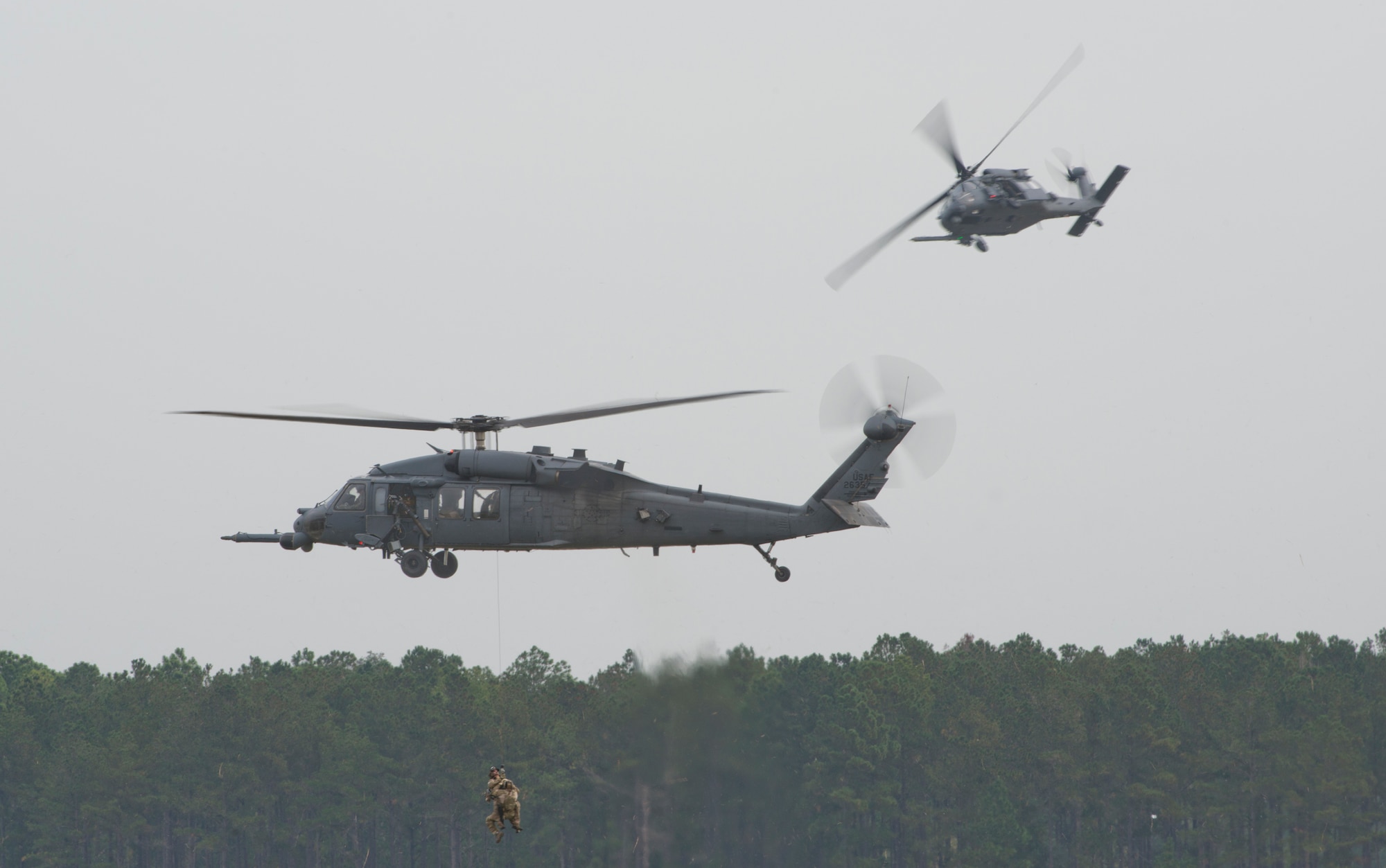 Pararescuemen from the 38th Rescue Squadron rescue a simulated downed pilot during the Moody Air Force Base, Ga., Legacy of Liberty Open House air show Oct. 27, 2012. The combat search and rescue demonstration showcased Moody’s capabilities in a deployed environment. (U.S. Air Force photo by Senior Airman Douglas Ellis/Released) 
