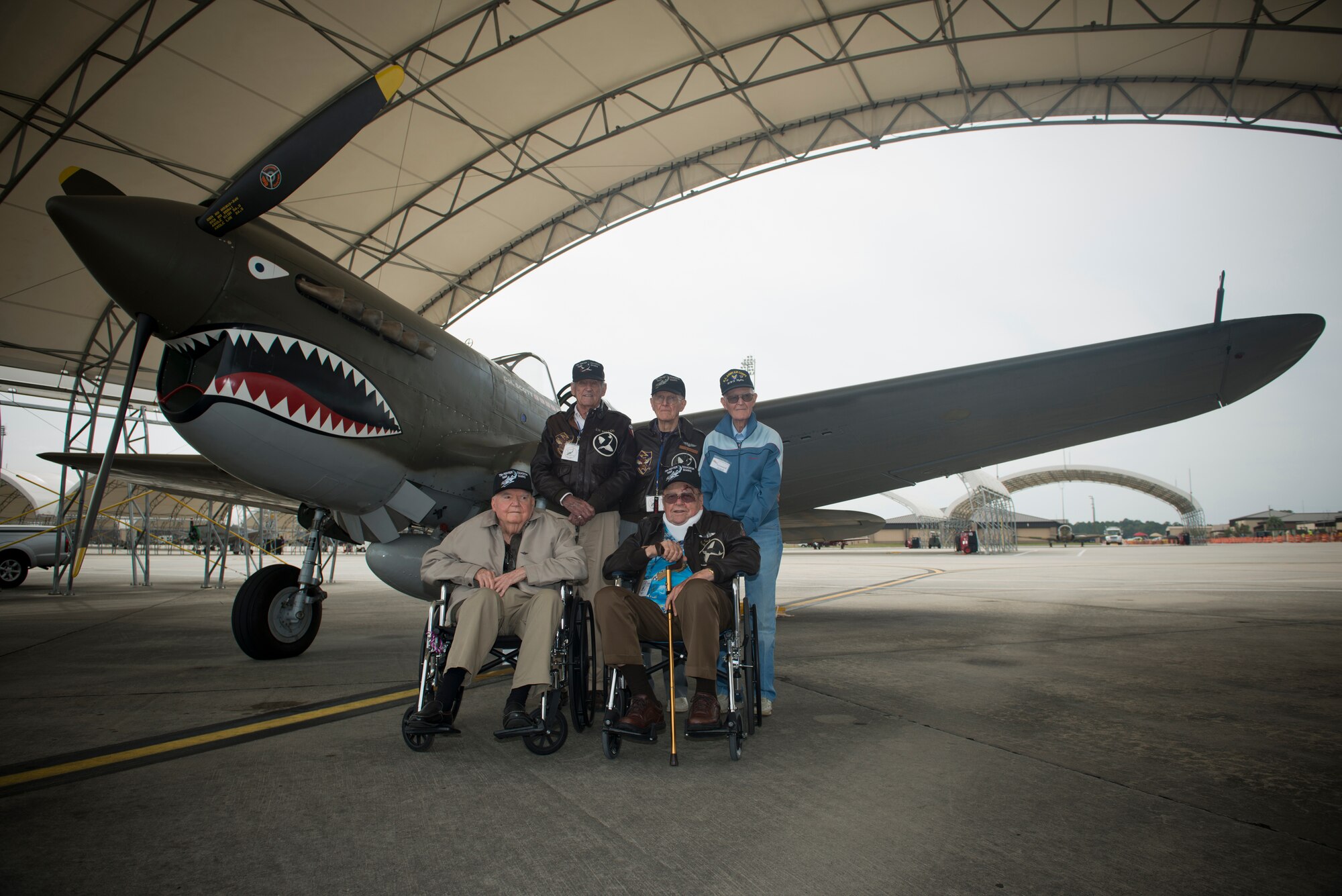 Original Flying Tigers from World War II gather next to a P-40 Warhawk during the Moody Air Force Base, Ga., Legacy of Liberty Open House air show Oct. 27, 2012. During World War II, the original Flying Tigers famously painted shark teeth on P-40 Warhawks, a tradition still followed and used on today's A-10s within the 23d Fighter Group at Moody. (U.S. Air Force photo by Senior Airman Douglas Ellis/Released)
