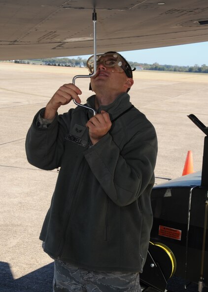 Senior Airman Trevor Howell, 2nd Maintenance Squadron crew chief, removes a fuel manifold panel on a B-52H Stratofortress on Barksdale Air Force Base, La., Oct. 29. This process is done to remove the remaining fuel inside the aircraft in order to prevent it from venting out onto the ground. The B-52 has a fuel capacity of 312,197 lbs. (U.S. Air Force photo/Senior Airman Sean Martin)(RELEASED)