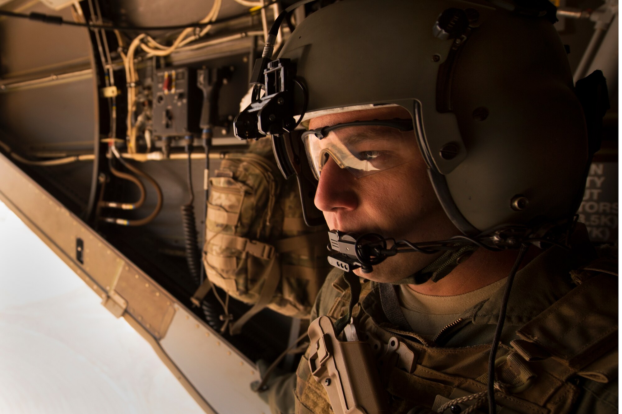 U.S. Air Force Staff Sgt. Steven Landmesser gazes out the back of a CV-22 Osprey during a flight for Air Commando spouses at Cannon Air Force Base, N.M., Oct. 27, 2012. Cannon's annual Spouses Orientation Flights offer a rare opportunity for husbands and wives to take to the skies in a military aircraft. (U.S. Air Force photo/Staff Sgt. Matthew Plew)