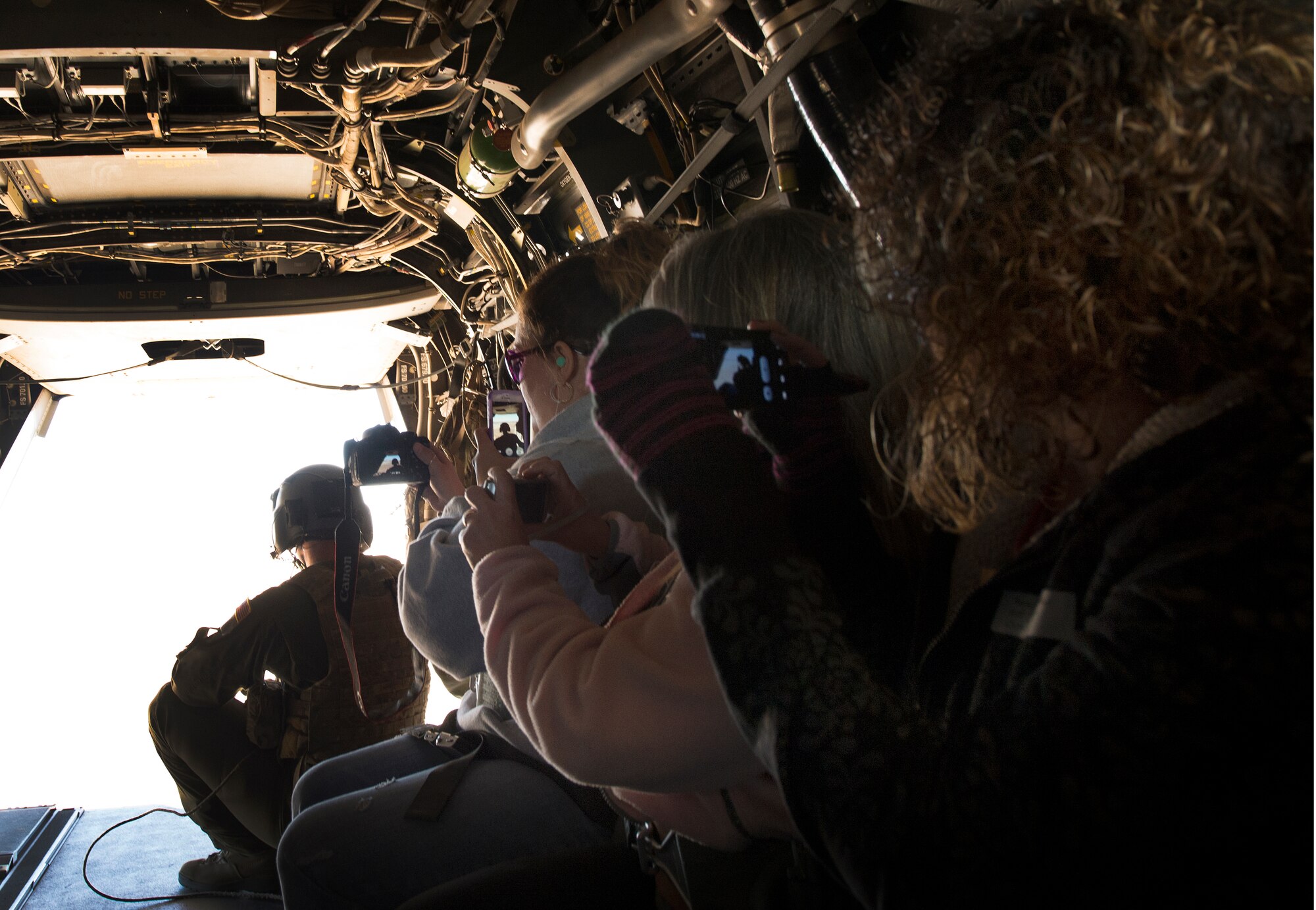 Air Commando spouses snap away pictures as they take their first flight in a CV-22 Osprey at Cannon Air Force Base, N.M., Oct. 27, 2012. Cannon's annual Spouses Orientation Flights offer a rare opportunity for husbands and wives to take to the skies in a military aircraft. (U.S. Air Force photo/Staff Sgt. Matthew Plew)