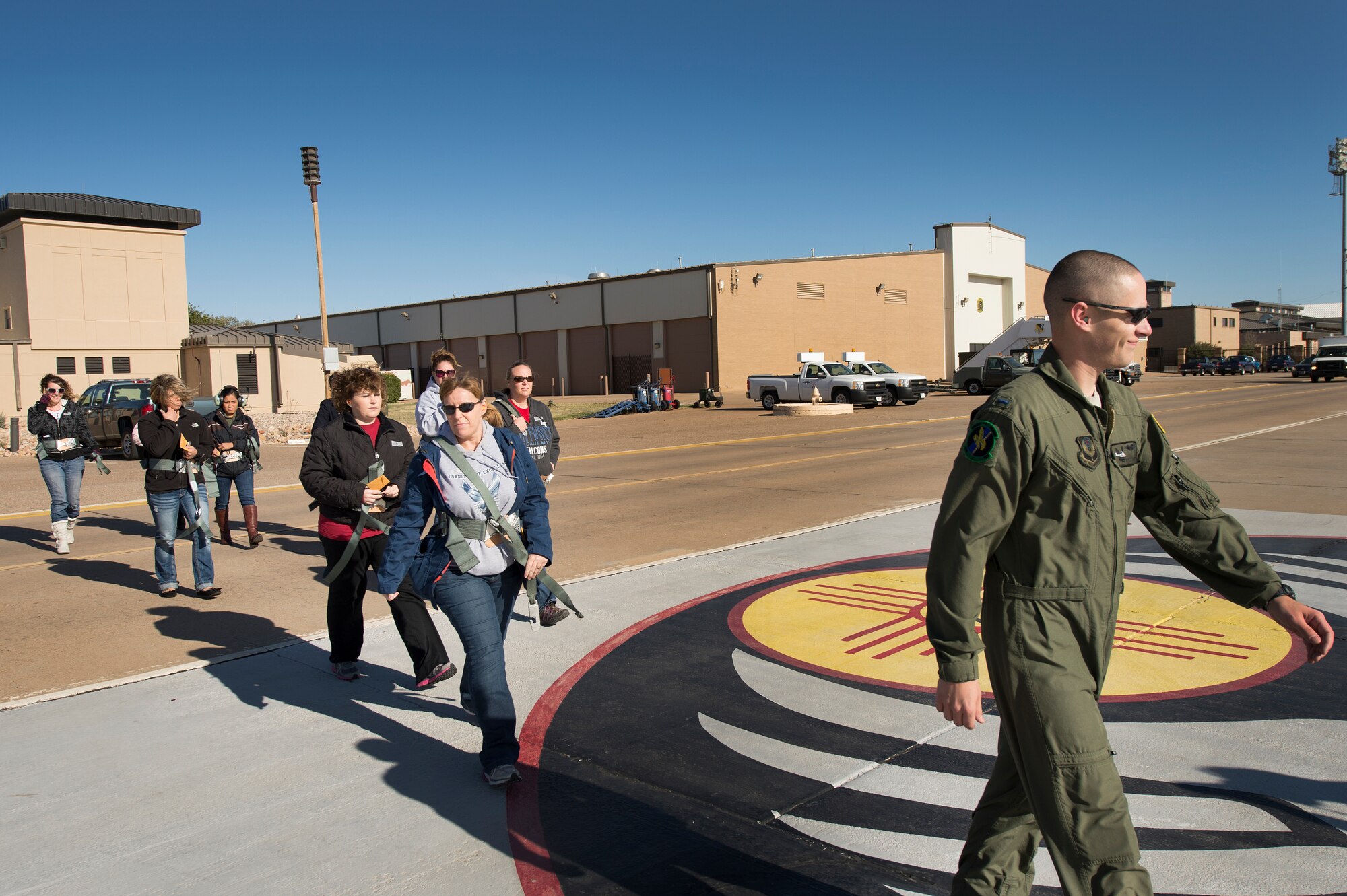 Air Commando spouses are escorted to on to the flight line by aircrew members of the 20th Special Operations Squadron at Cannon Air Force Base, N.M., Oct. 27, 2012. Cannon's annual Spouses Orientation Flights offer a rare opportunity for husbands and wives to take to the skies in a military aircraft. (U.S. Air Force photo/Staff Sgt. Matthew Plew) 