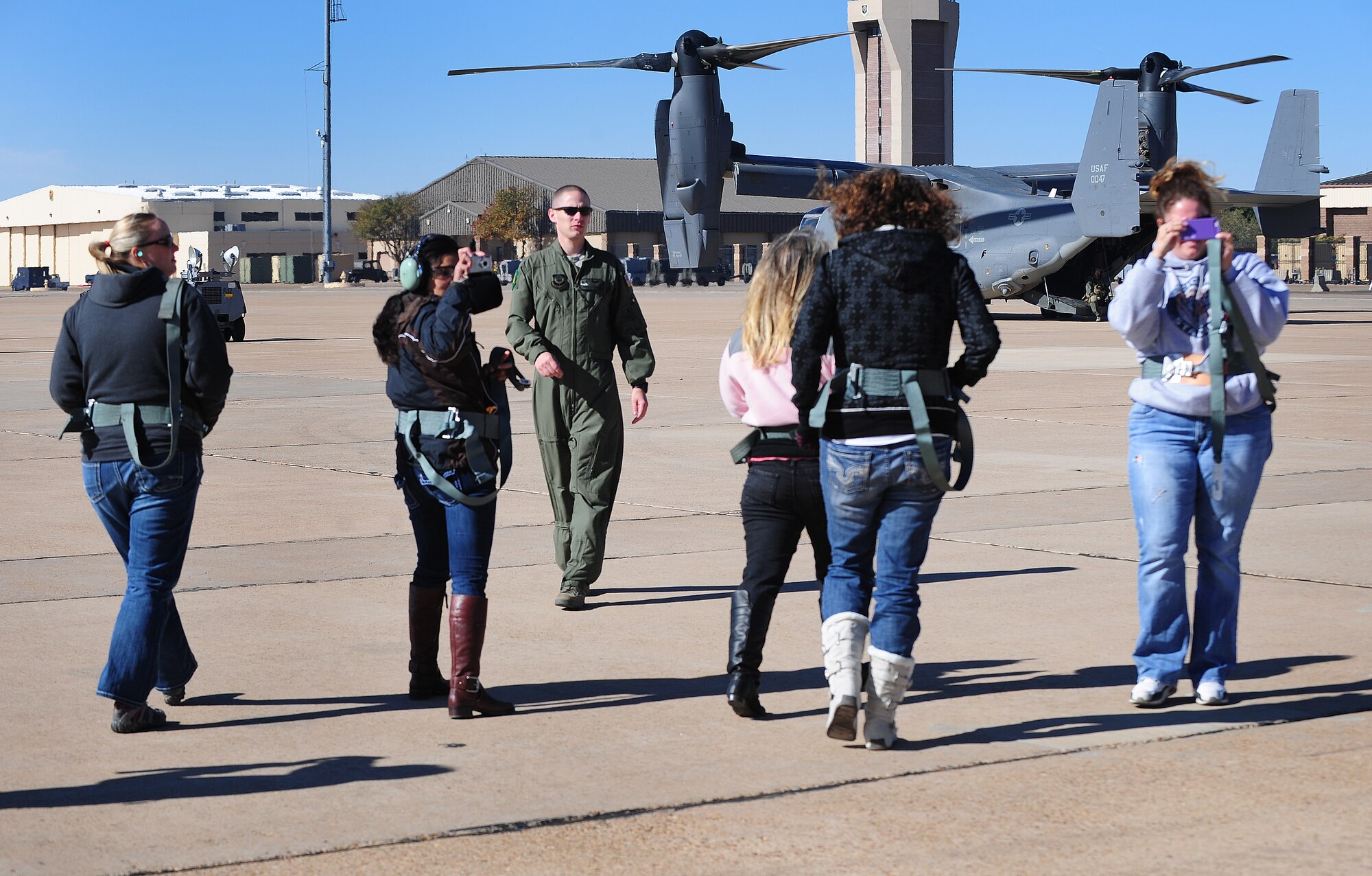 Spouses of U.S. Air Force members stationed at Cannon Air Force Base, N.M., Oct 27, 2012, disembark the CV-22 Osprey. Husbands and wives of Air Commandos are welcomed to the base and given the chance to ride in a military aircraft during annual Spouse Orientation Flights. (U.S. Air Force photo/Airman 1st Class Ericka Engblom)