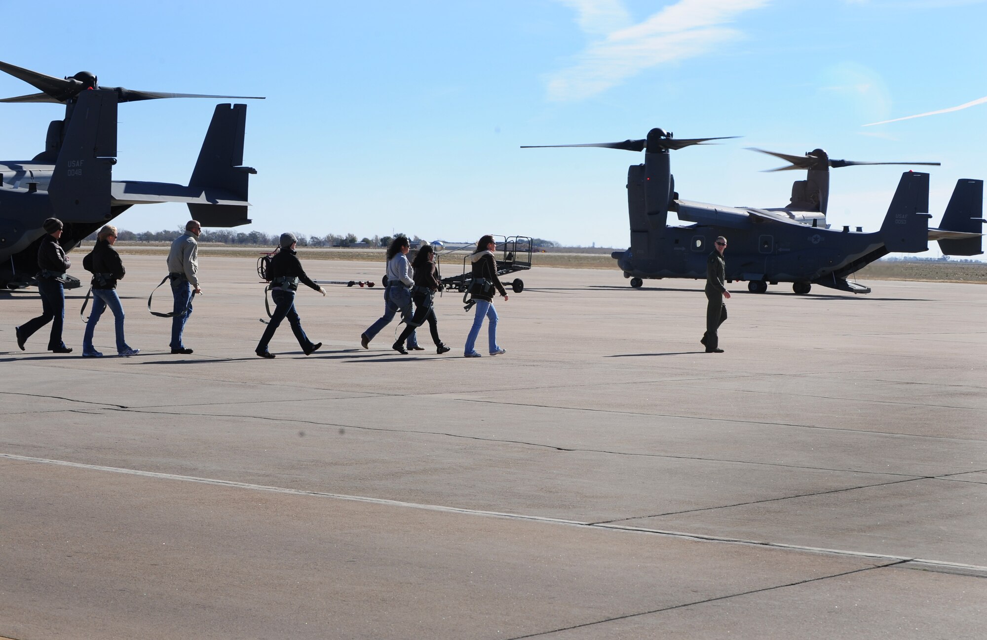 A member of the 20th Special Operations Squadron leads spouses to a CV-22 Osprey at Cannon Air Force Base, N.M., Oct 27, 2012. Husbands and wives of Air Commandos are welcomed to the base and given the chance to ride in a military aircraft during annual Spouse Orientation Flights. (U.S. Air Force photo/Airman 1st Class Ericka Engblom)