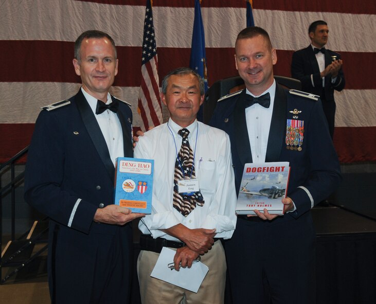 U.S. Air Force Cols. Billy Thompson, 23d Wing commander, and Ronald Stuewe, 23d Fighter Group commander, stand with James Eng, 23d Flying Tigers Association, during the 2012 Flying Tigers Reunion dinner at the James H. Rainwater Conference Center in Valdosta, Ga., Oct. 26, 2012. Thompson and Stuewe received gifts of appreciation from Eng for hosting this year’s reunion. (U.S. Air Force photo by Airman 1st Class Olivia Bumpers/Released)