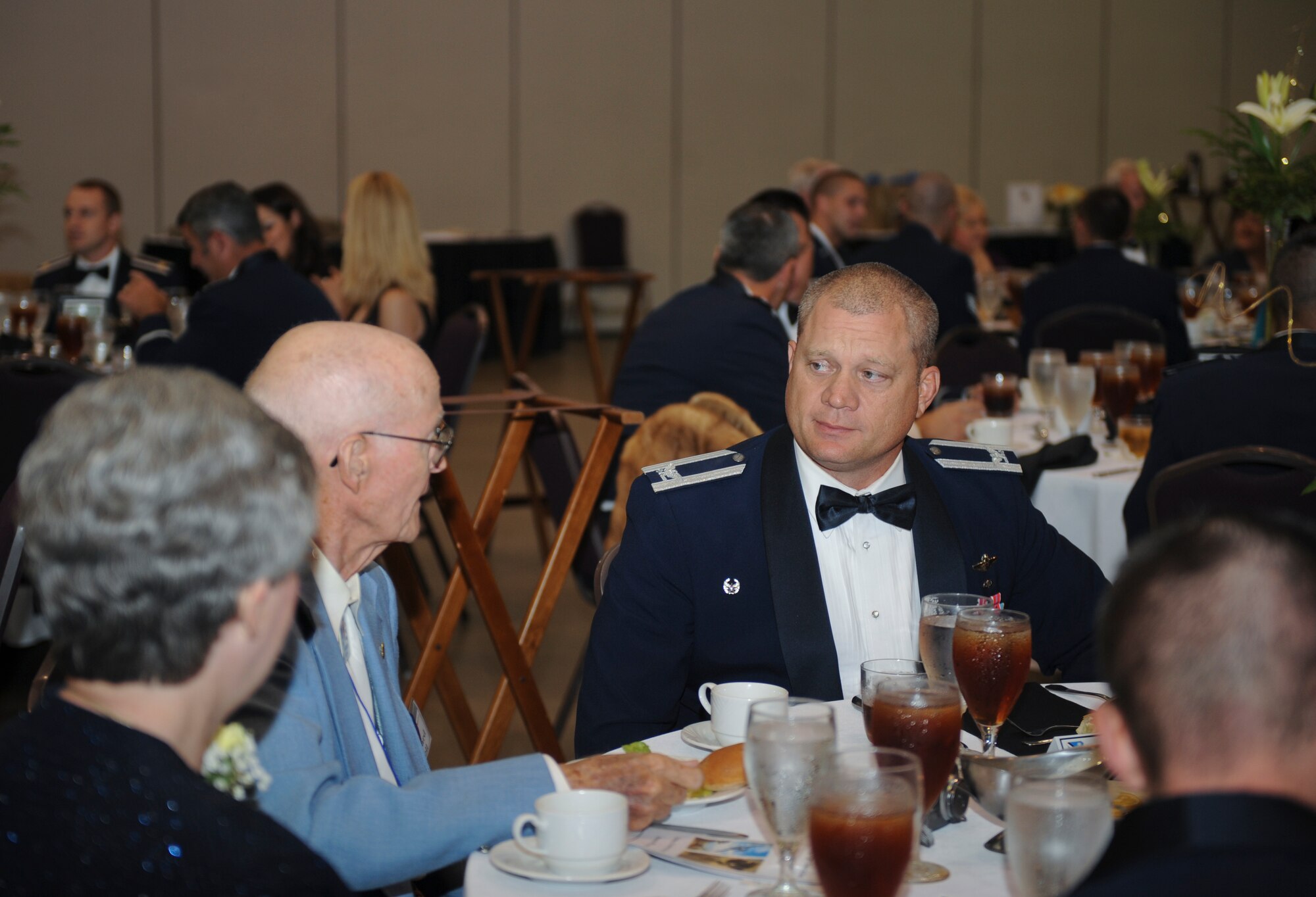 U.S. Air Force Col. Samuel Milam, 93d Air Ground Operations Wing commander, speaks with Leonard Miller, former Flying Tiger, during the 2012 Flying Tiger Reunion dinner at the James H. Rainwater Conference Center in Valdosta, Ga., Oct. 26, 2012.  Past and present Flying Tigers attended the reunion dinner to honor 71 years of Flying Tiger history. (U.S. Air Force photo by Airman 1st Class Olivia Bumpers/Released)