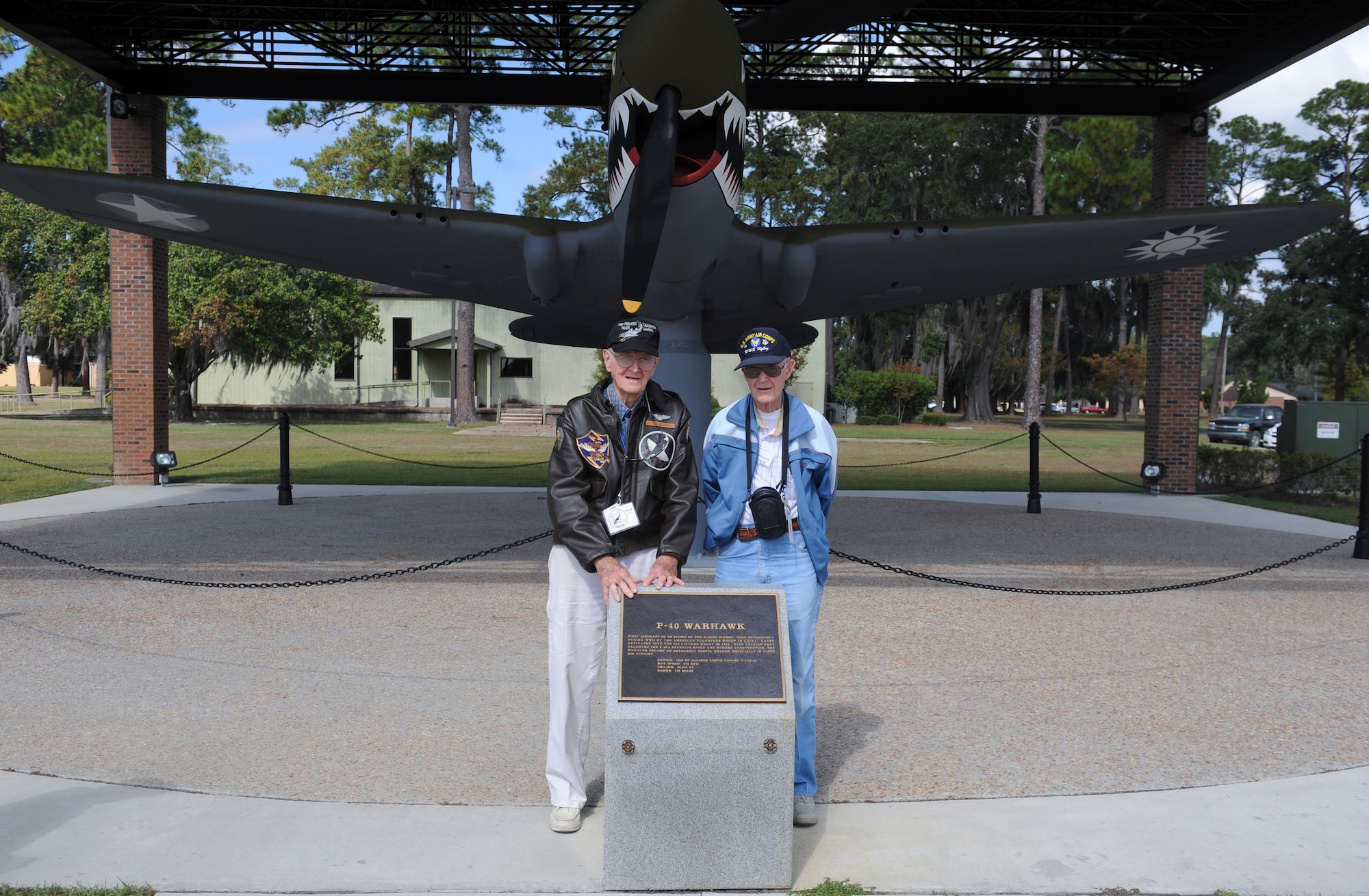 Former Flying Tigers, Donald Miller, left, and Leonard O’Dell stand by a P-40 Warhawk static display during the 2012 Flying Tigers Reunion at Moody Air Force Base, Ga., Oct. 25, 2012. The reunion allowed original WWII veterans the chance to share war stories among themselves and with current Flying Tiger pilots. (U.S. Air Force photo by Airman 1st Class Olivia Bumpers/Released)